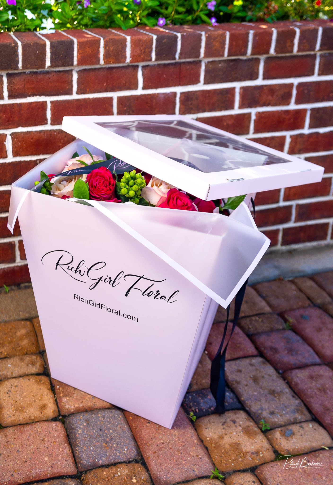 Pink gift box with roses and greenery inside
