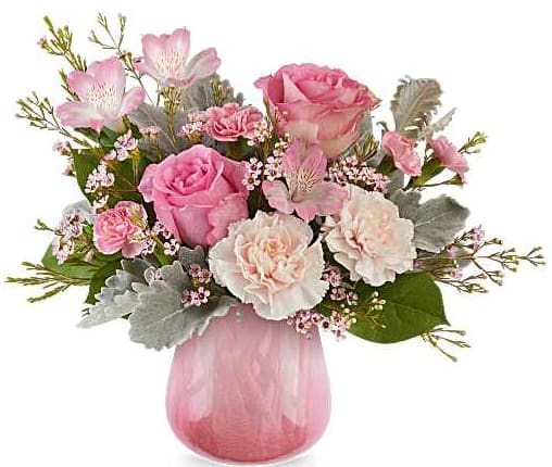 Pink roses and carnations in a pink glass vase