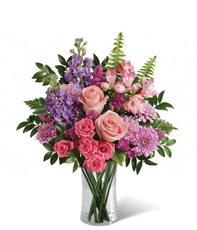 Pink and purple mixed bouquet in a clear glass vase