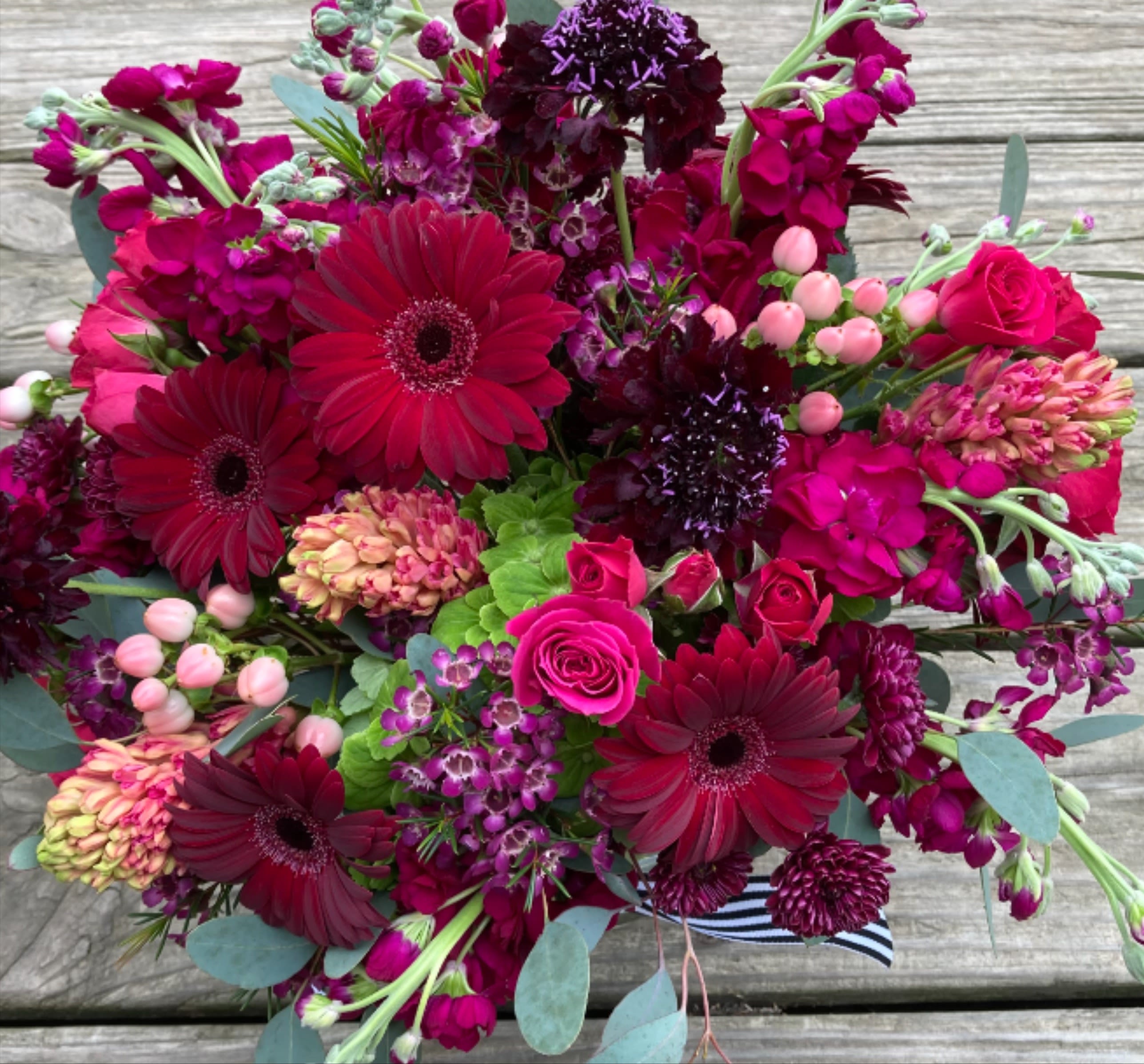 DESIGNERS COICE-Rich and Moody - Designer Choice, made with rich and moody colors, in reds, burgundys and purples. The bouquets are made with seasonal, high quality, mixed blooms. Photo is an example.