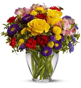 Brighten Your Day - With an abundant array of bright red, yellow and purple flowers, this arrangement is sure to brighten your day.  Roses, alstroemeria, asters, carnations and chrysanthemums are delivered in a cheerful clear glass vase.  Approximately 12" W x 13" H  Orientation: All-Around      As Shown : TF107-1 