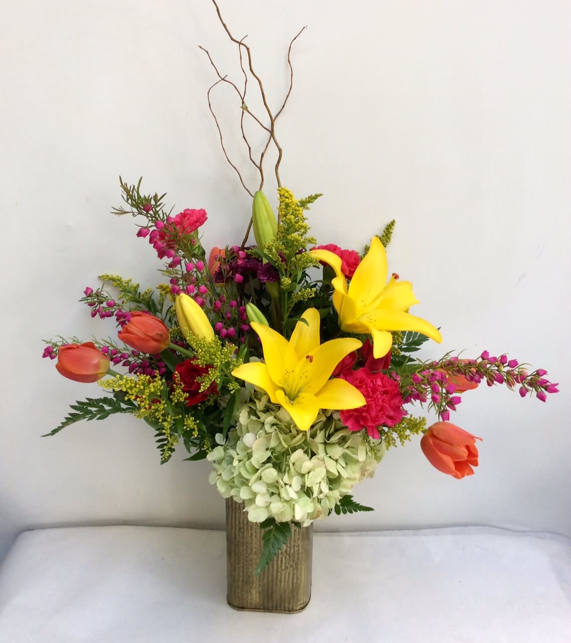Springtime Love by Hudson Flower Shop - Garden favorites including lilies, tulips, roses and more in a whimsical garden vessel.