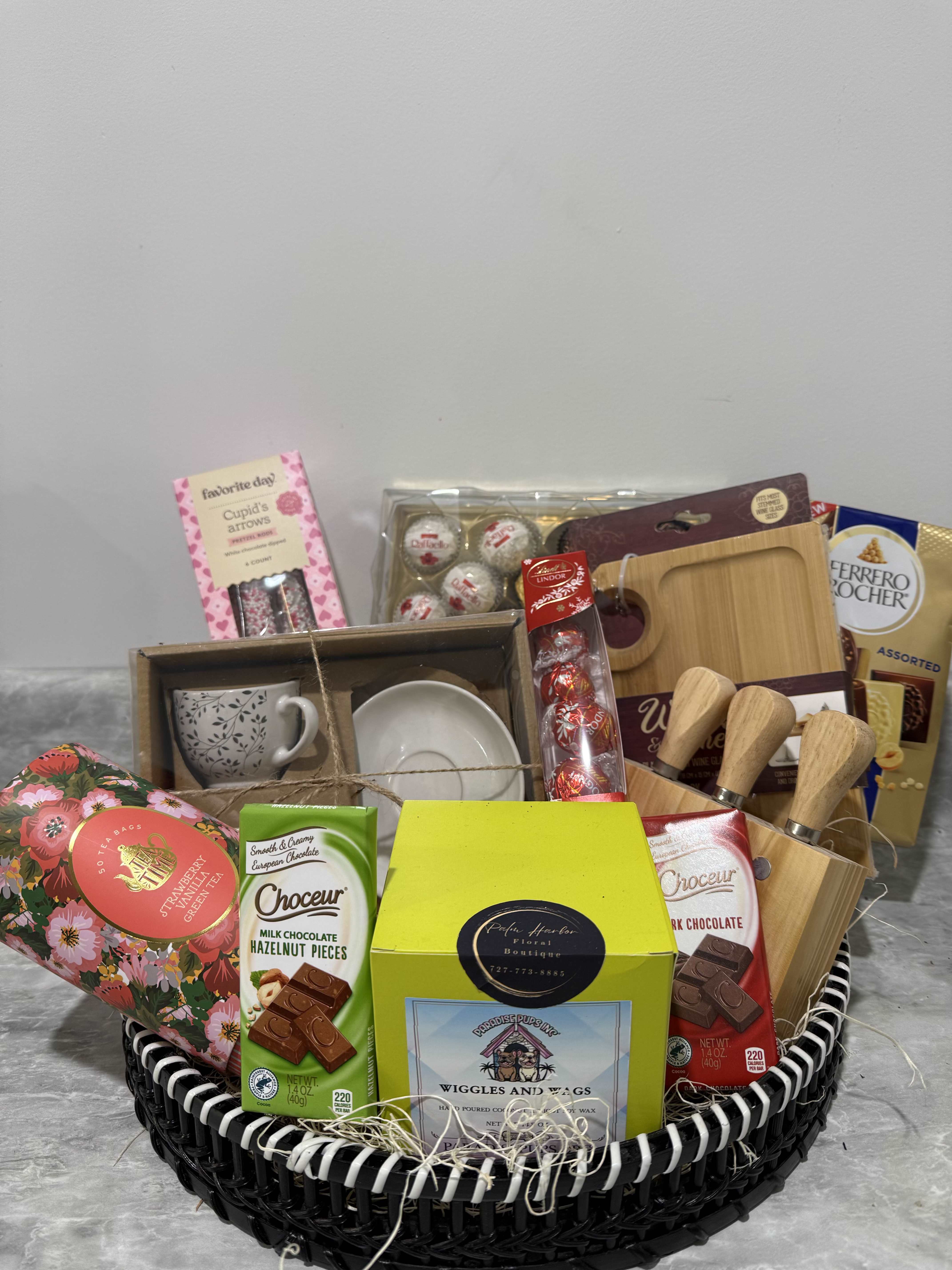 Mother’s Day Treats Collection - A beautifully curated basket filled with chocolates, coffee set, tea, dipped pretzels, and gourmet treats, paired with a stylish appetizer platter—perfect for celebrating Mom.