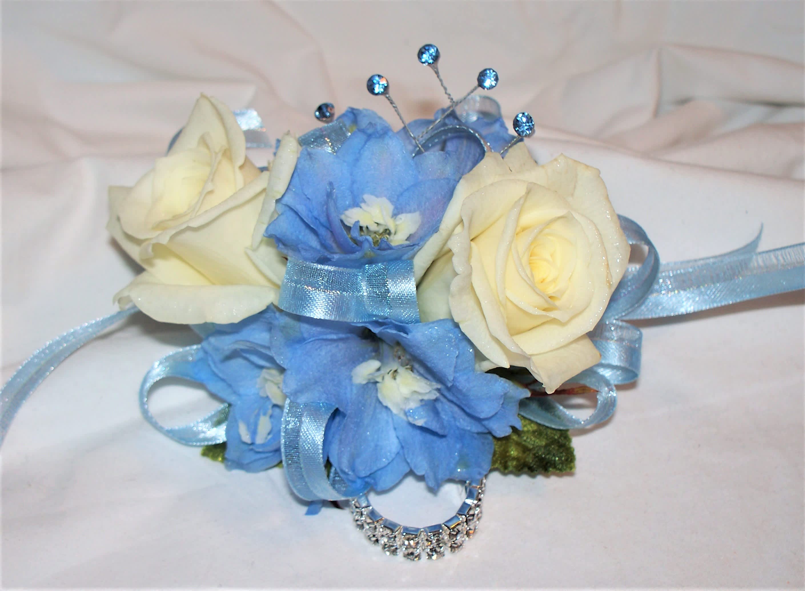 Blue and cream floral wrist corsage with ribbon and rhinestone accents