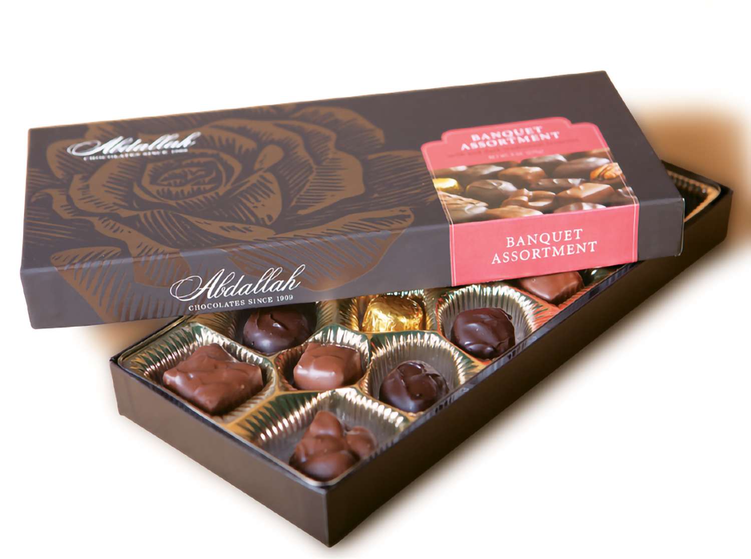 Open box of assorted chocolates with a matching lid