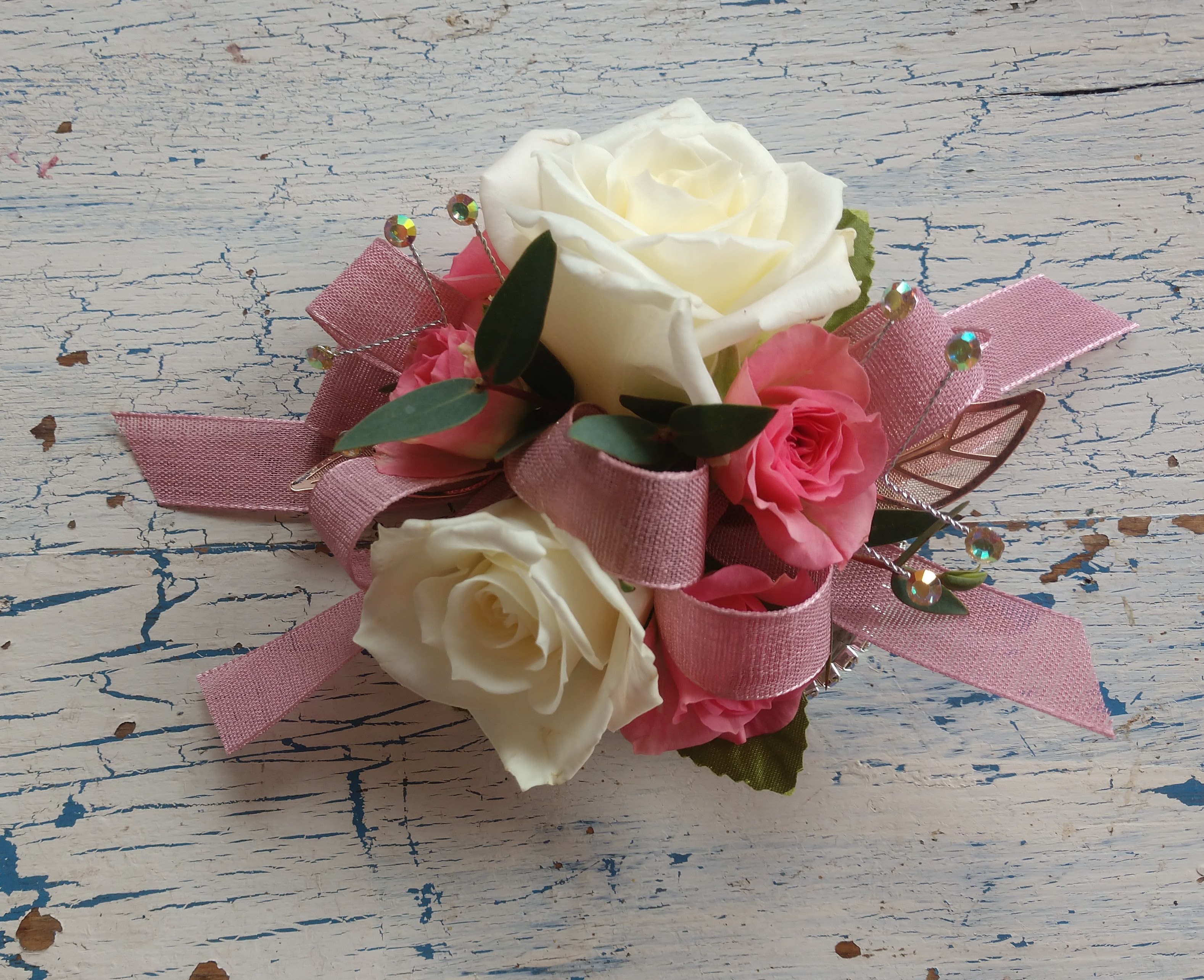 Pink and white rose corsage with ribbon accents