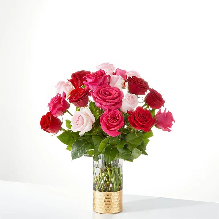 Bouquet of pink and red roses in a clear glass vase