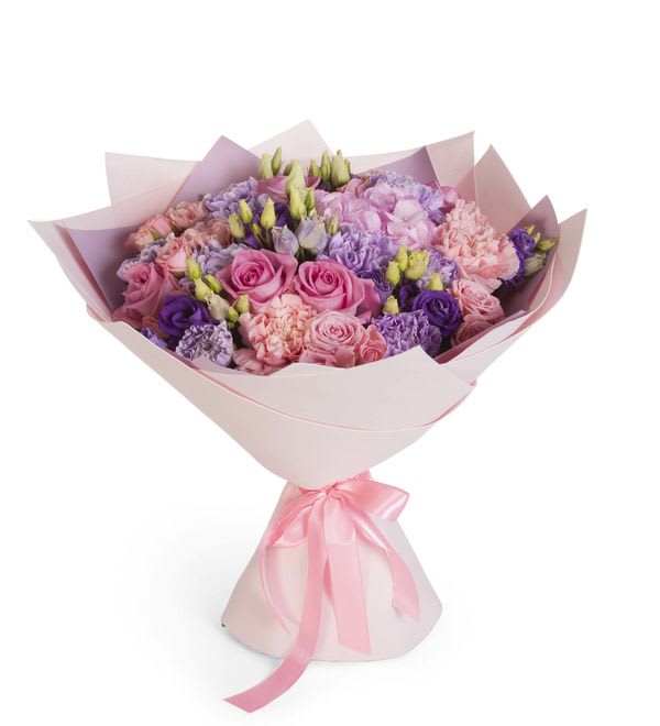 Bouquet of pink, purple, and lavender flowers wrapped in pale pink paper