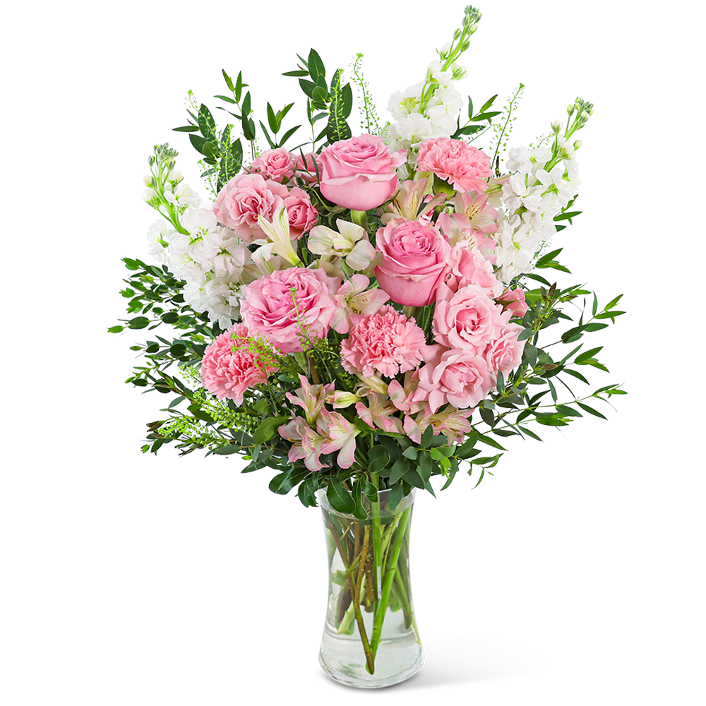Pink roses and white flowers arranged in a clear glass vase