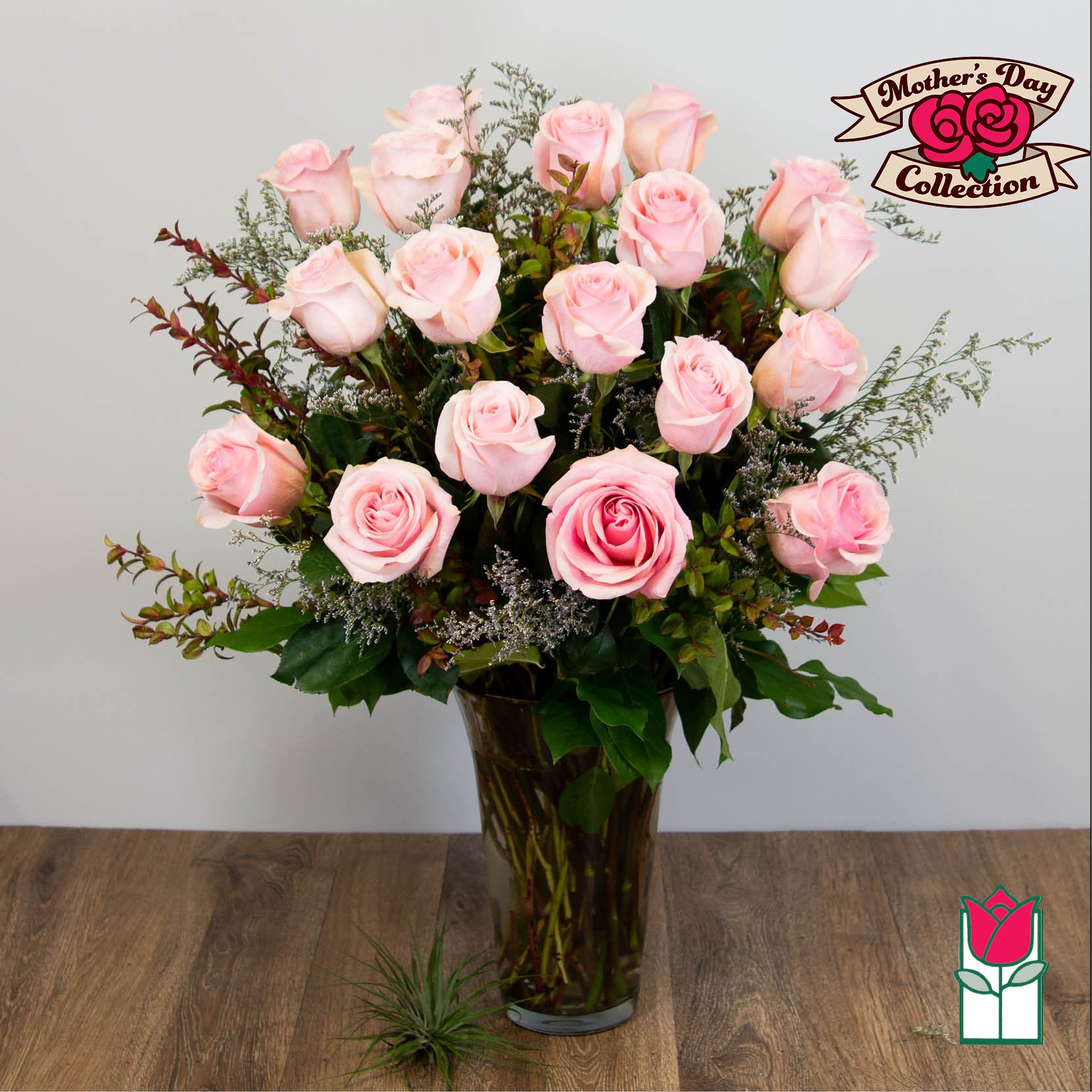 Pink roses arranged in a tall glass vase