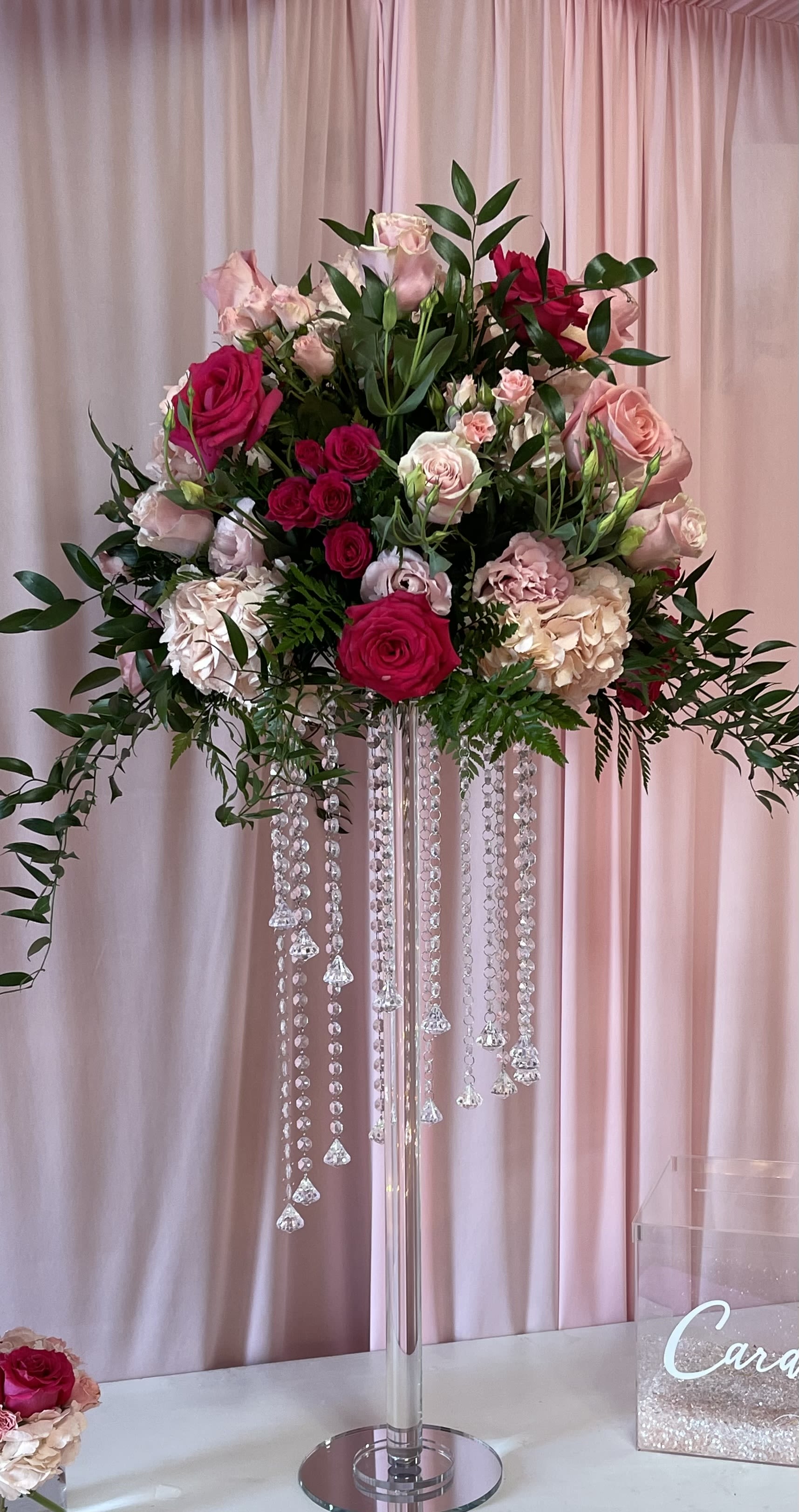 Pinks on tall glass vase - Two piece floral sitting in tall glass/acrylic vase 