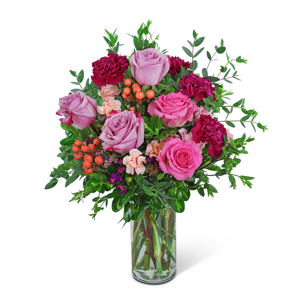 Pink roses and carnations in a clear glass vase