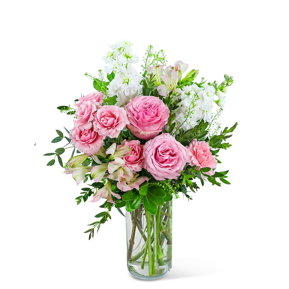 Pink roses and white flowers arranged in a clear glass vase