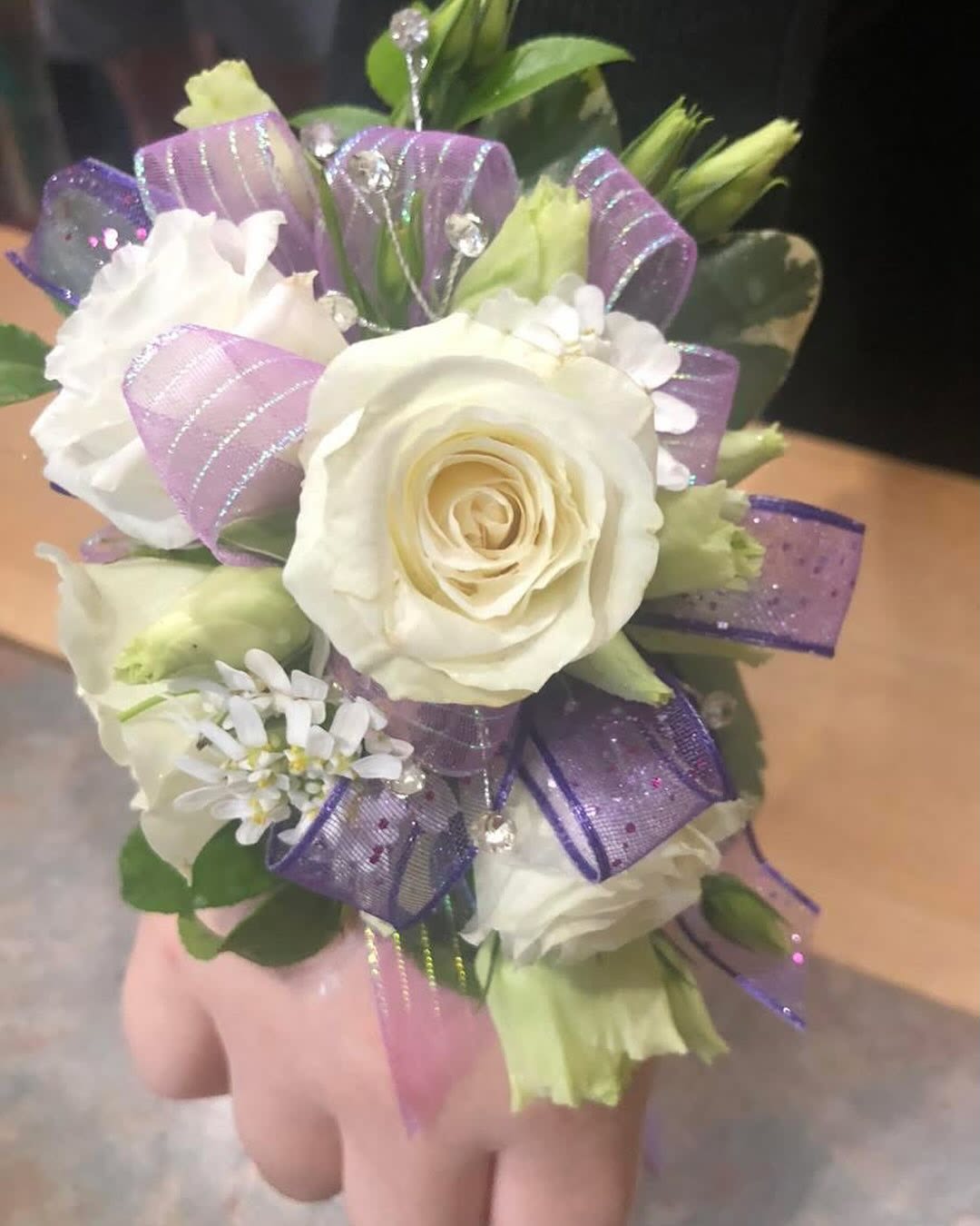 WHITE ROSE WITH LAVENDER RIBBON PROM CORSAGE - An example of a corsage with white roses and lavender ribbon. Other colors may be available based on color/ribbon availability. Please text Darlene at 419-636-7813 with a picture of your dress so we can match the corsage to the dress