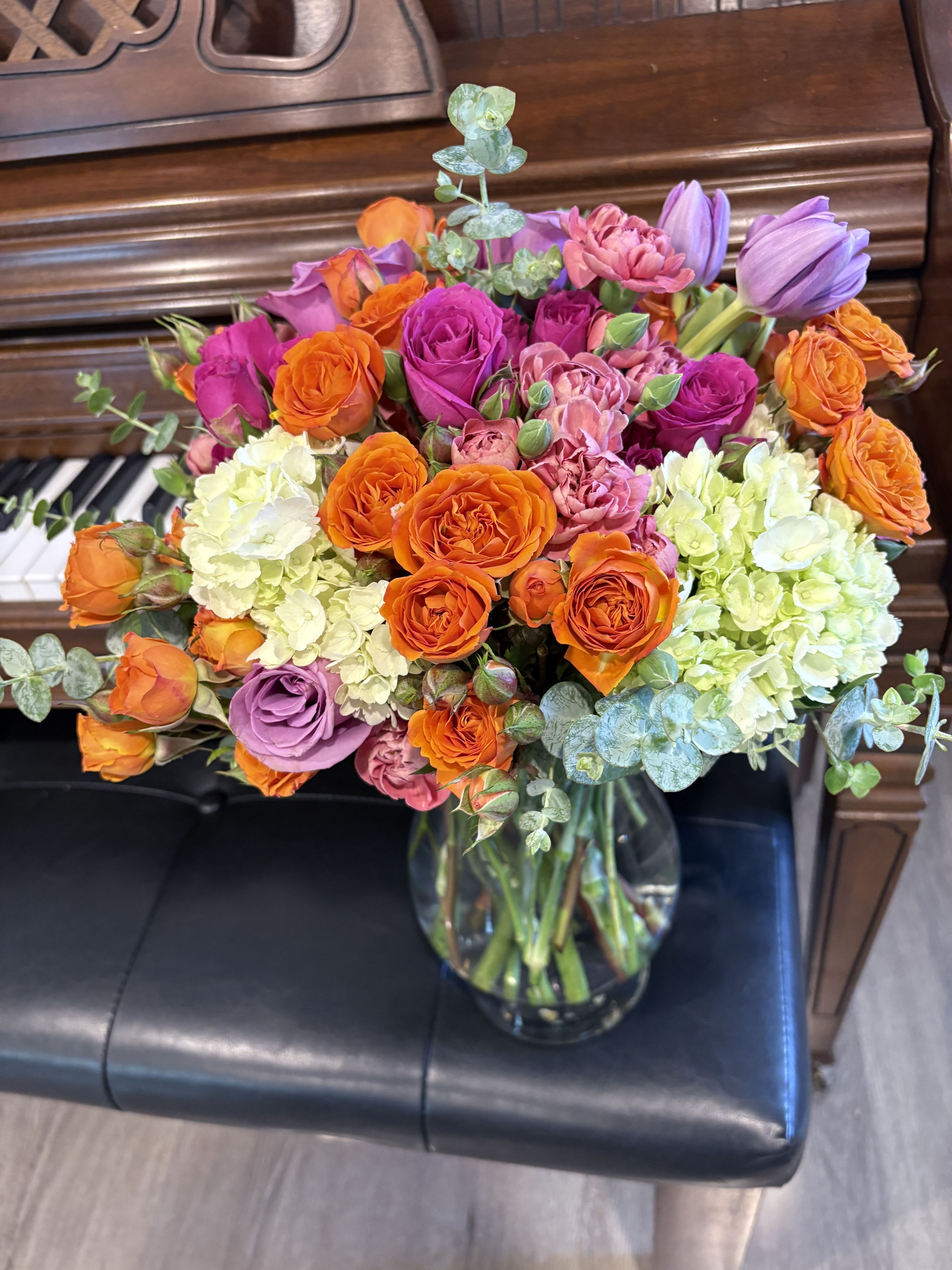 Spring Bloom Delight - This vibrant floral arrangement captures the essence of spring with a stunning mix of colors and cheerful blooms. Perfect centerpiece for any spring celebration or as a delightful gift to brighten someone's day