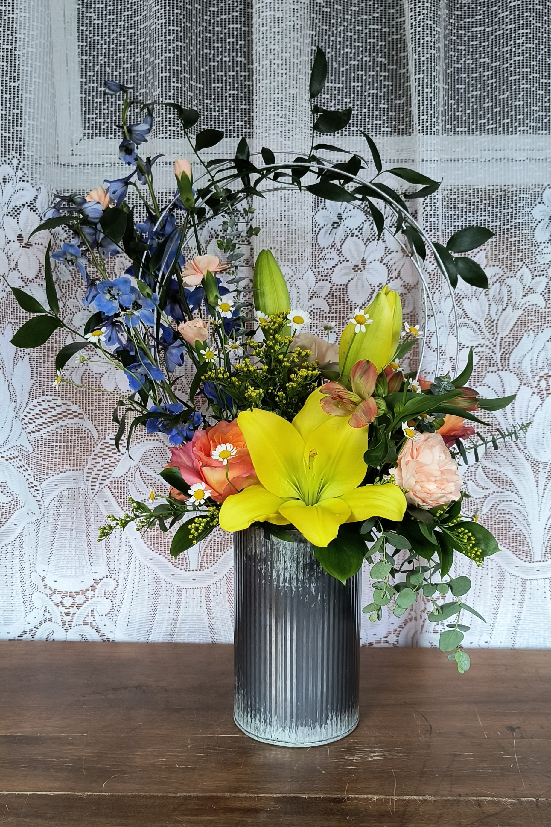 Bliss - A trendy design of garden flowers to include stock, lily, roses and alstroemeria but not limited to. Colors may vary from picture.