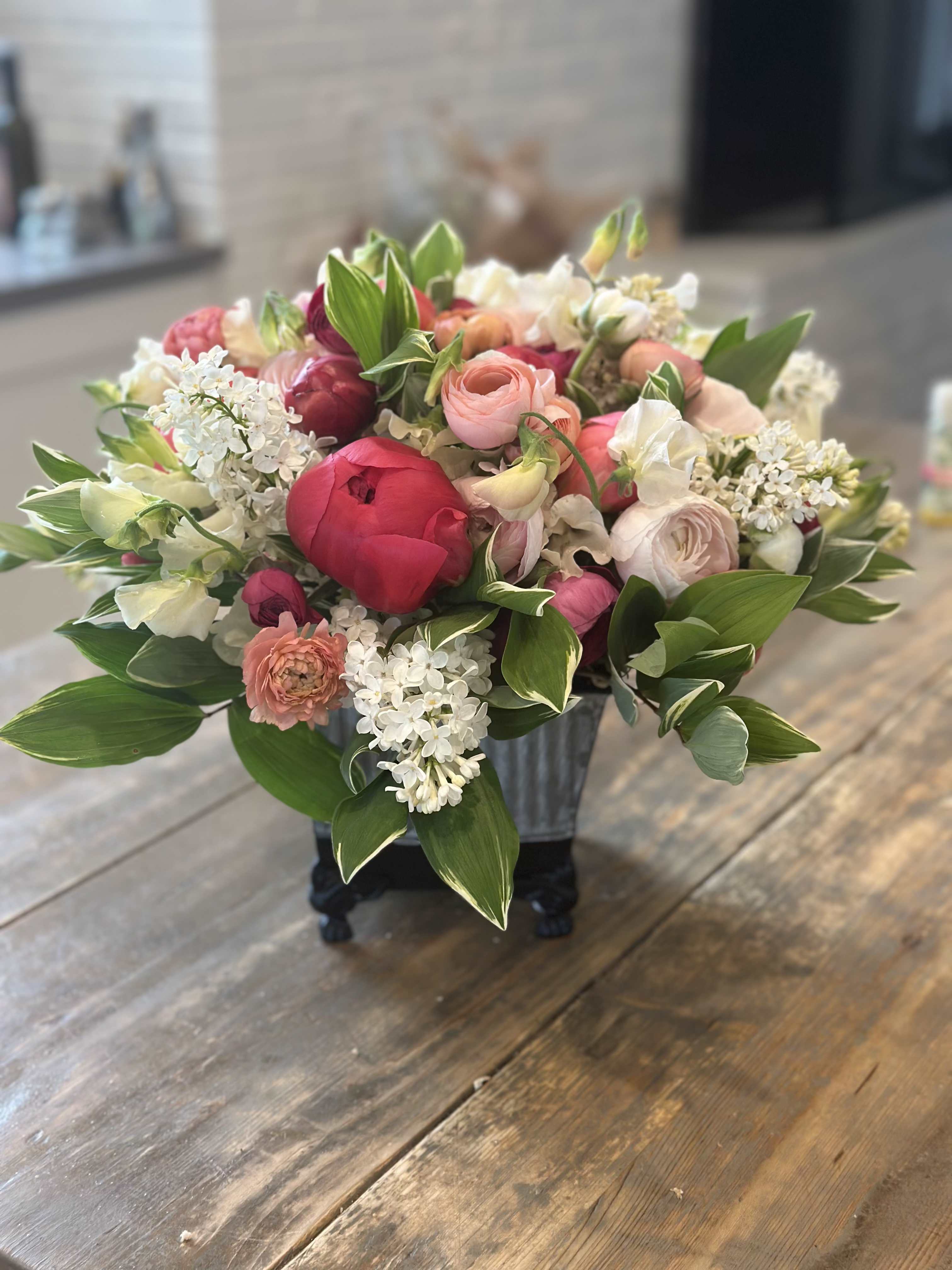 Mixed pink and white bouquet in a black container