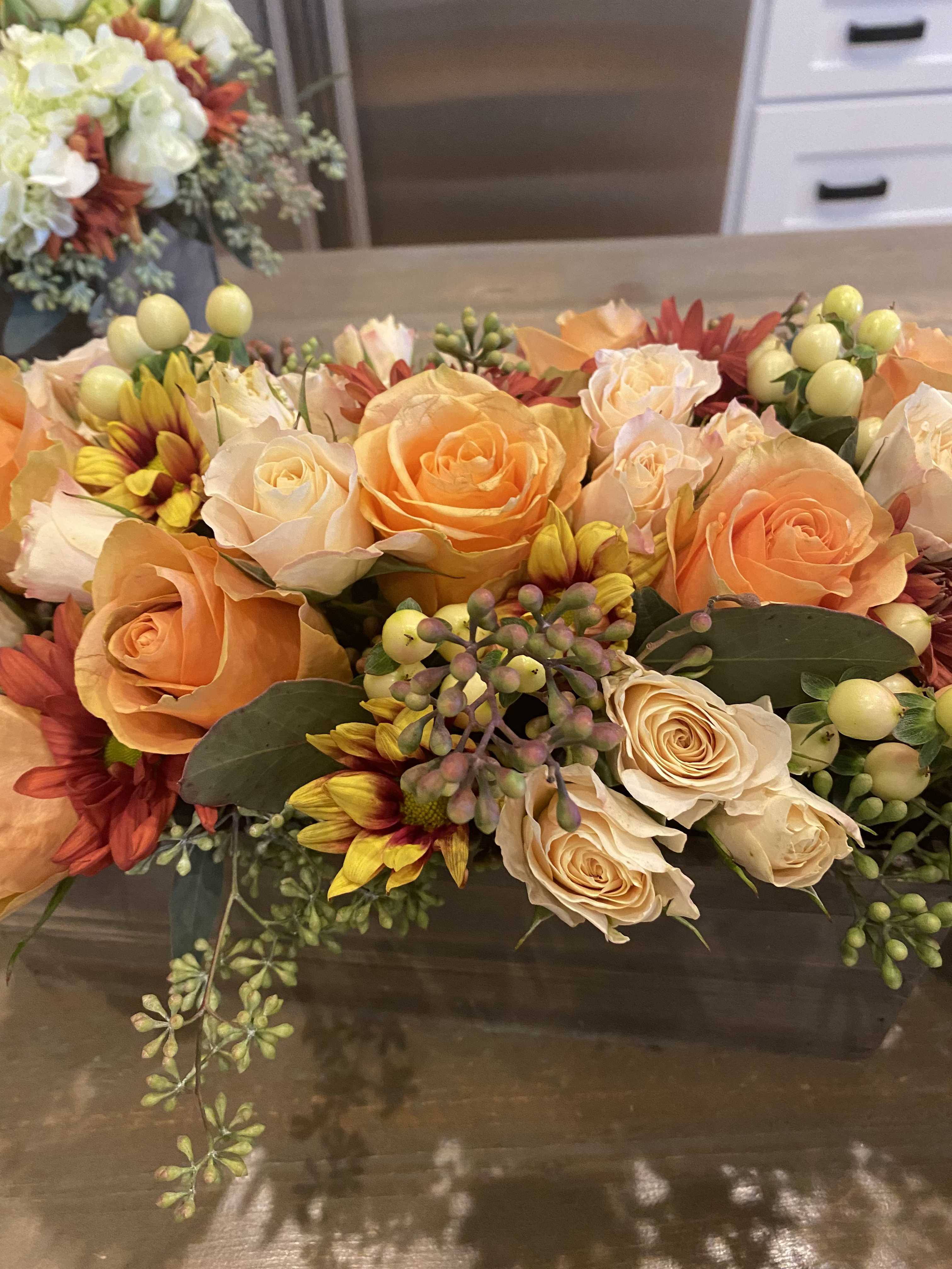 Peach and cream rose bouquet with yellow-red daisies and berry accents
