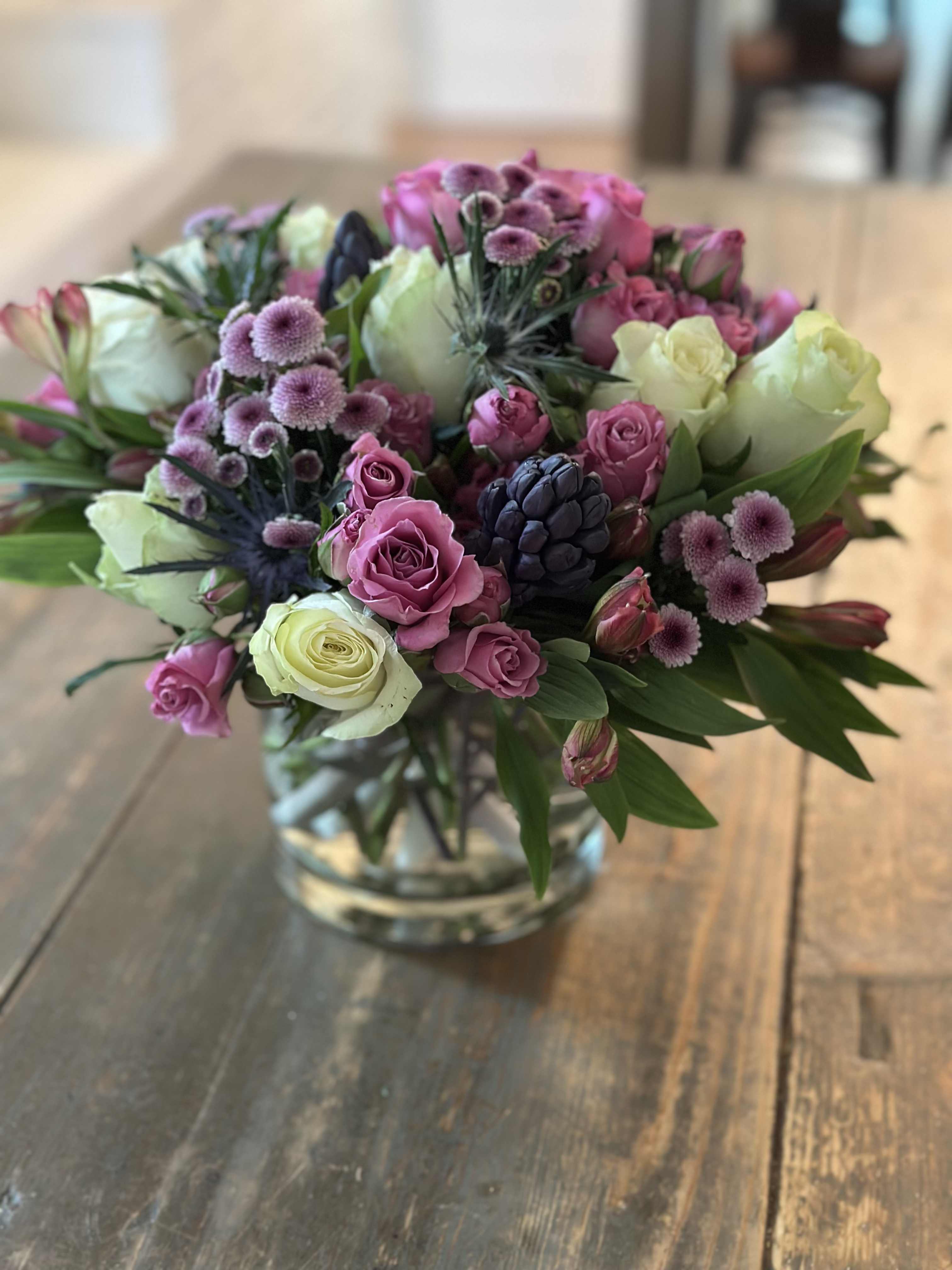 Pink and white rose bouquet in a clear glass vase