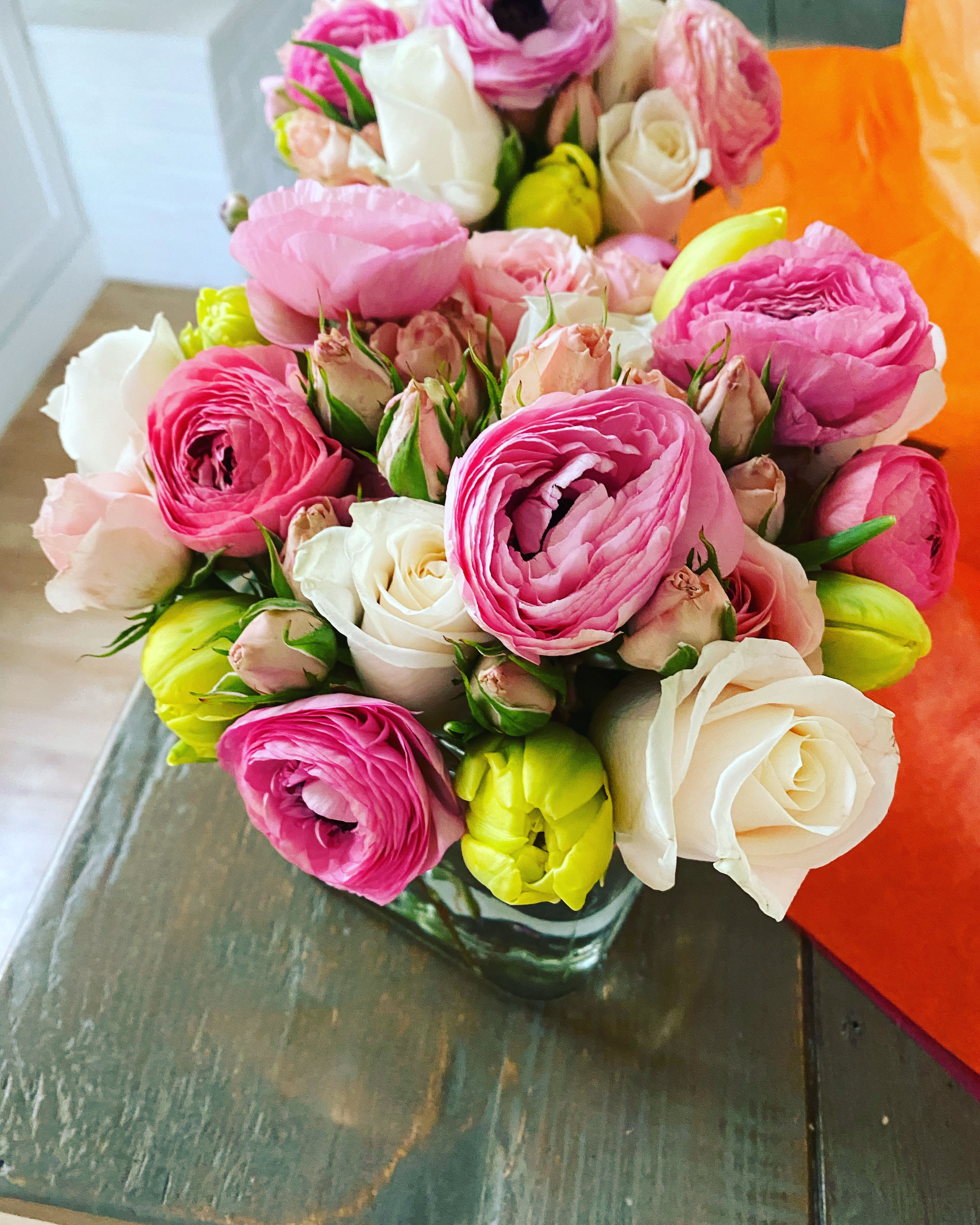 Bouquet of pink, white, and yellow flowers in a glass vase
