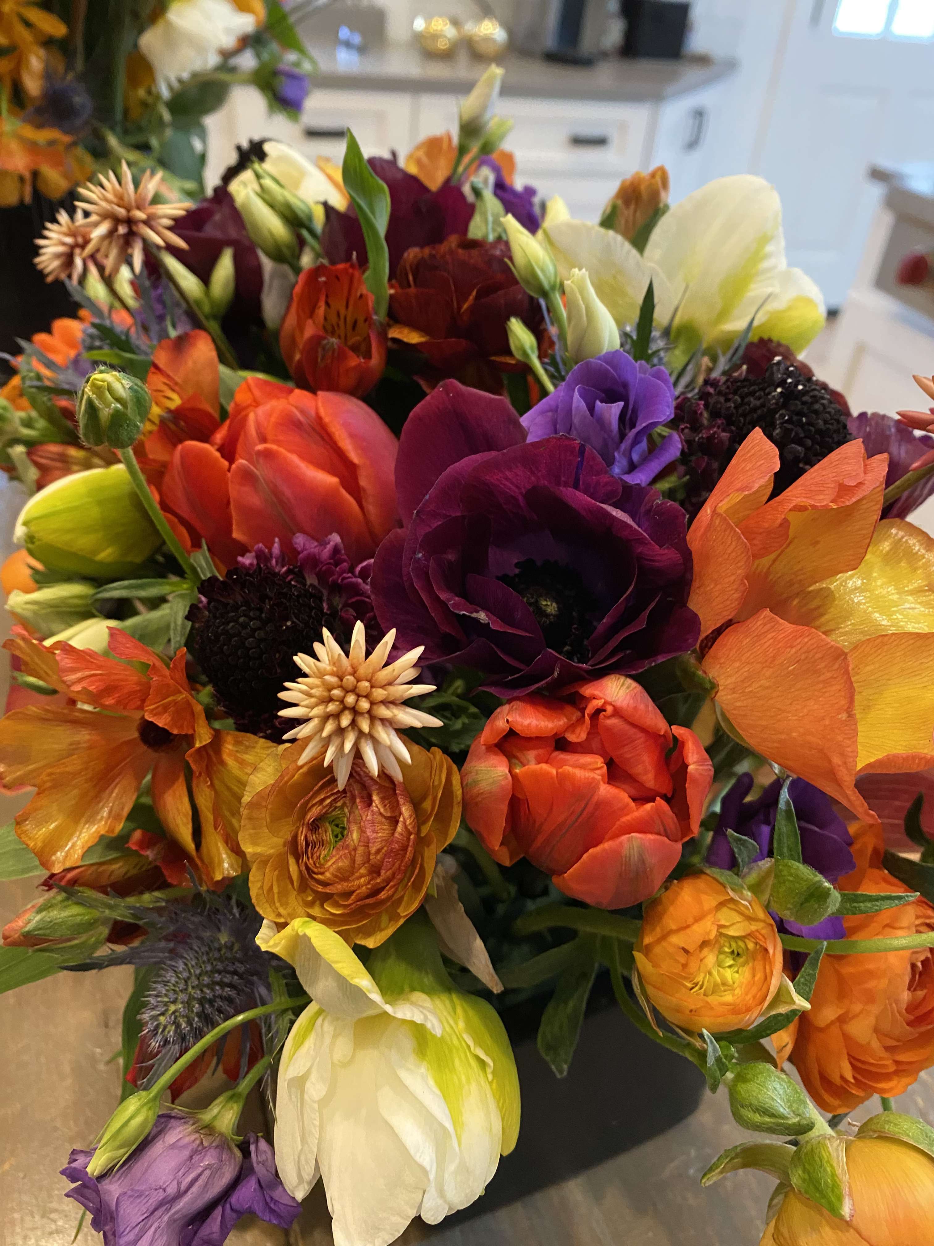 Bright mixed bouquet with orange, purple, yellow, and white blooms