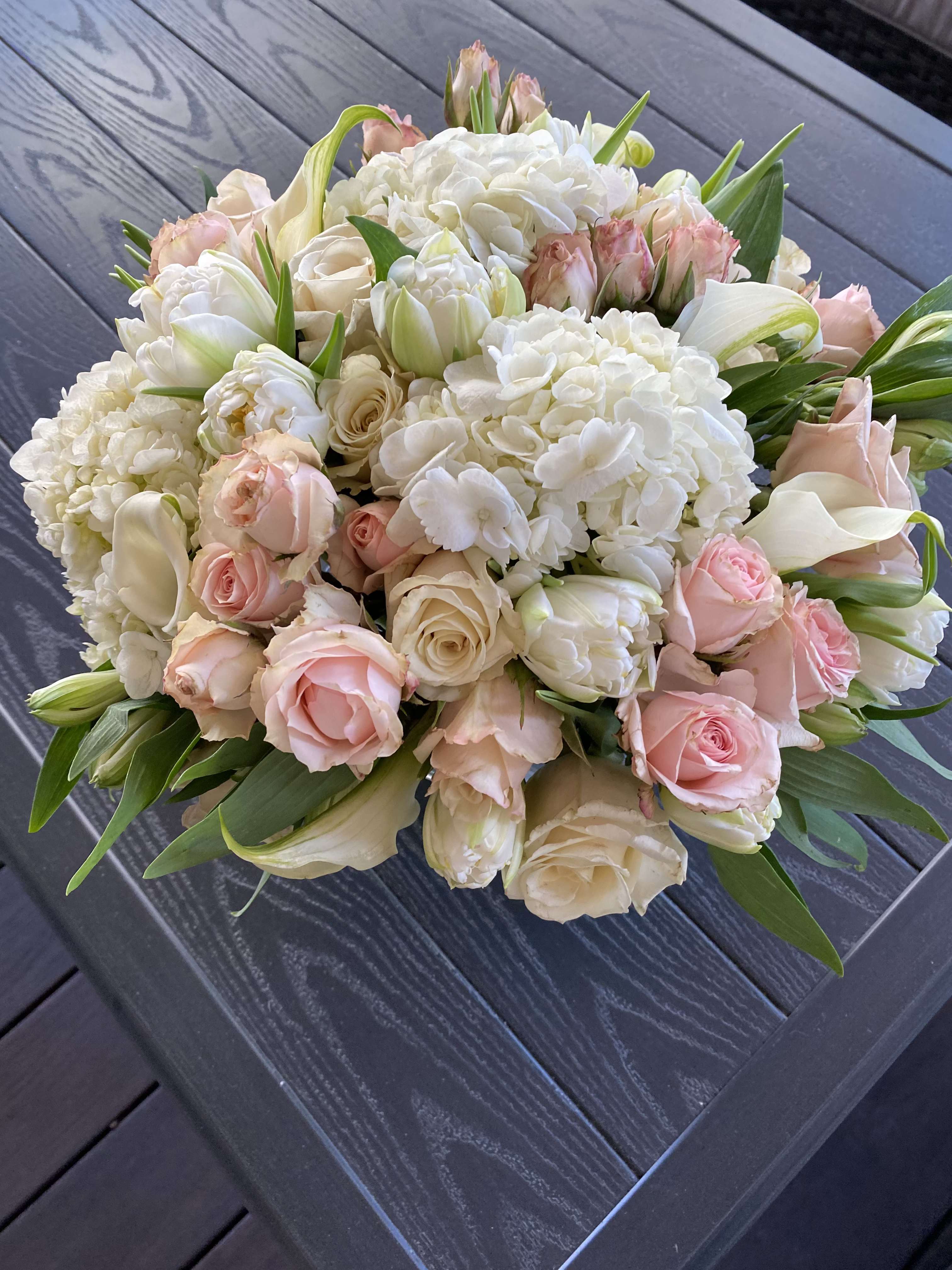 Bouquet of white hydrangeas, pale pink roses, and white tulips