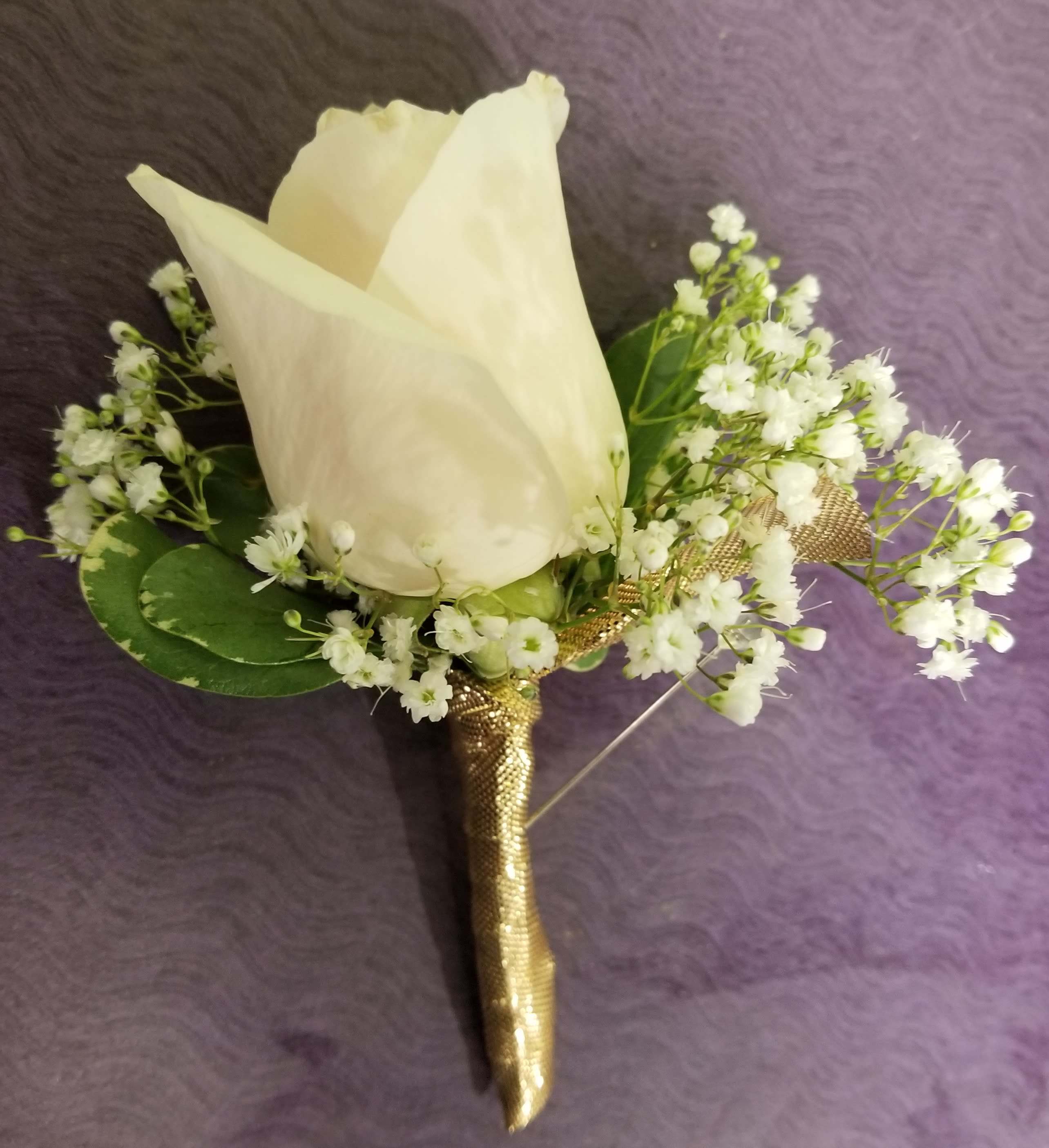 White rose boutonniere with baby's breath and gold wrap