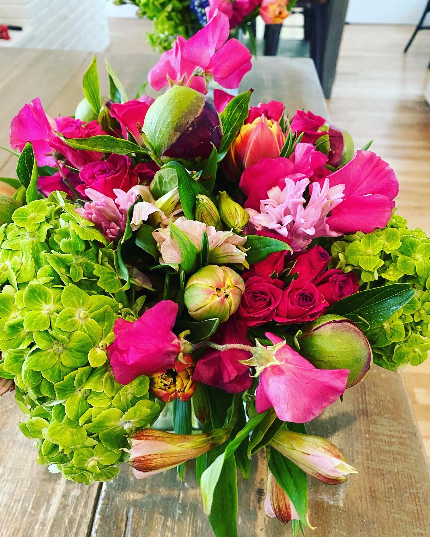 Bright bouquet of pink flowers with green hydrangeas and mixed blooms