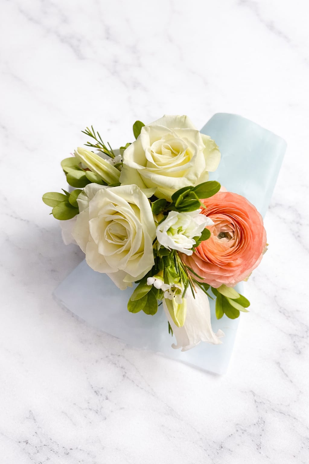 Prom corsage  - A handcrafted corsage featuring fresh roses, ranunculus, and delicate greenery in soft tones. Perfect for weddings, quinceañeras, proms, and special events, designed with precision and elegance to complement any look.