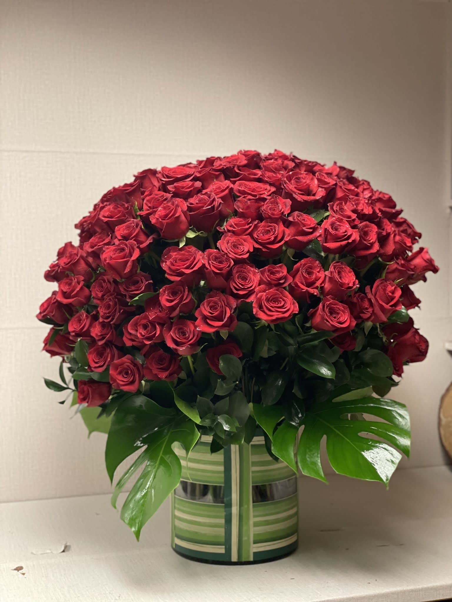 Large bouquet of red roses in a striped vase