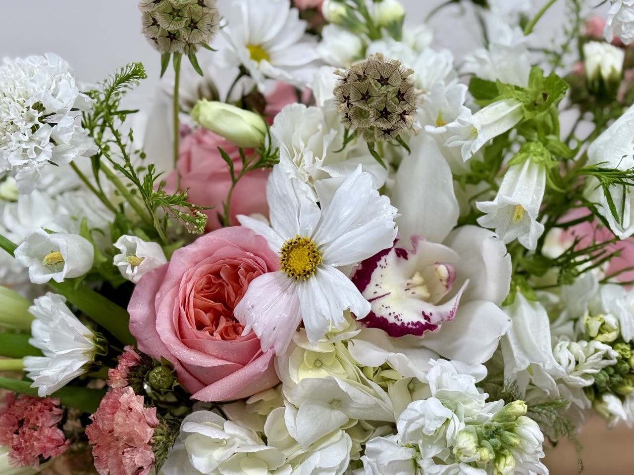 Pink rose bouquet with white flowers and green filler