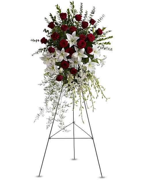 Lily and Rose Tribute Spray - Red roses, white asiatic lilies and delicate dendrobium orchids are accented with myrtle, sprengeri fern, leatherleaf fern and spiral eucalyptus on a traditional wire funeral easel. 50"H x 31"W