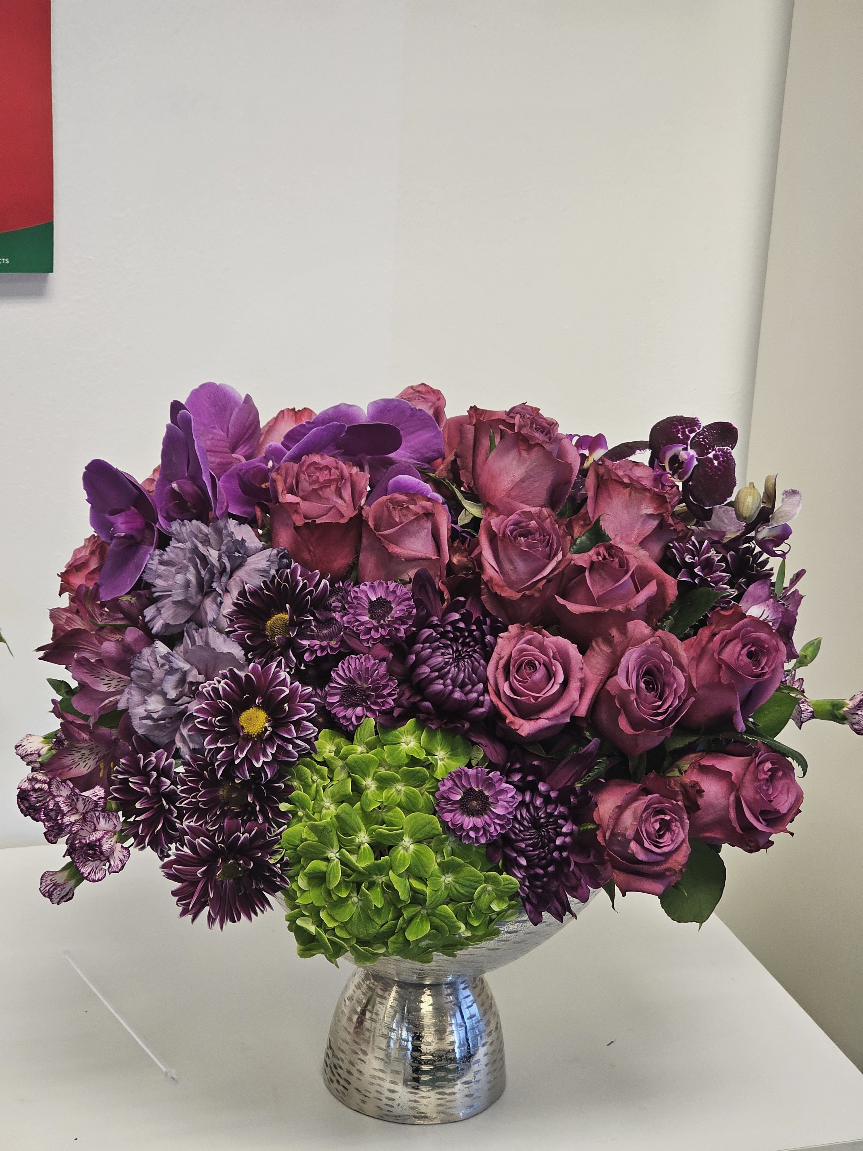 Purple and pink mixed bouquet in a silver vase