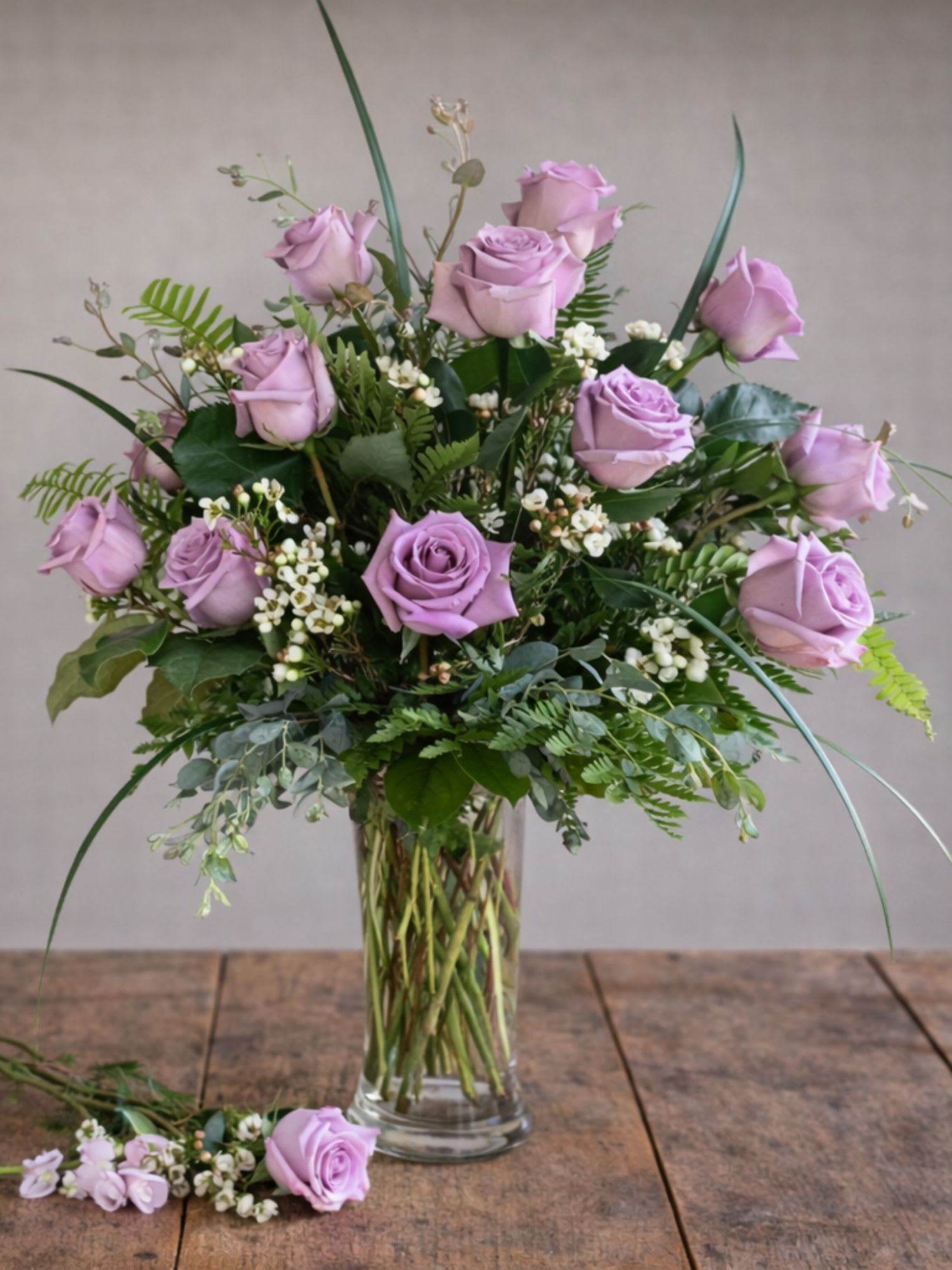 Lavender rose arrangement in a clear glass vase