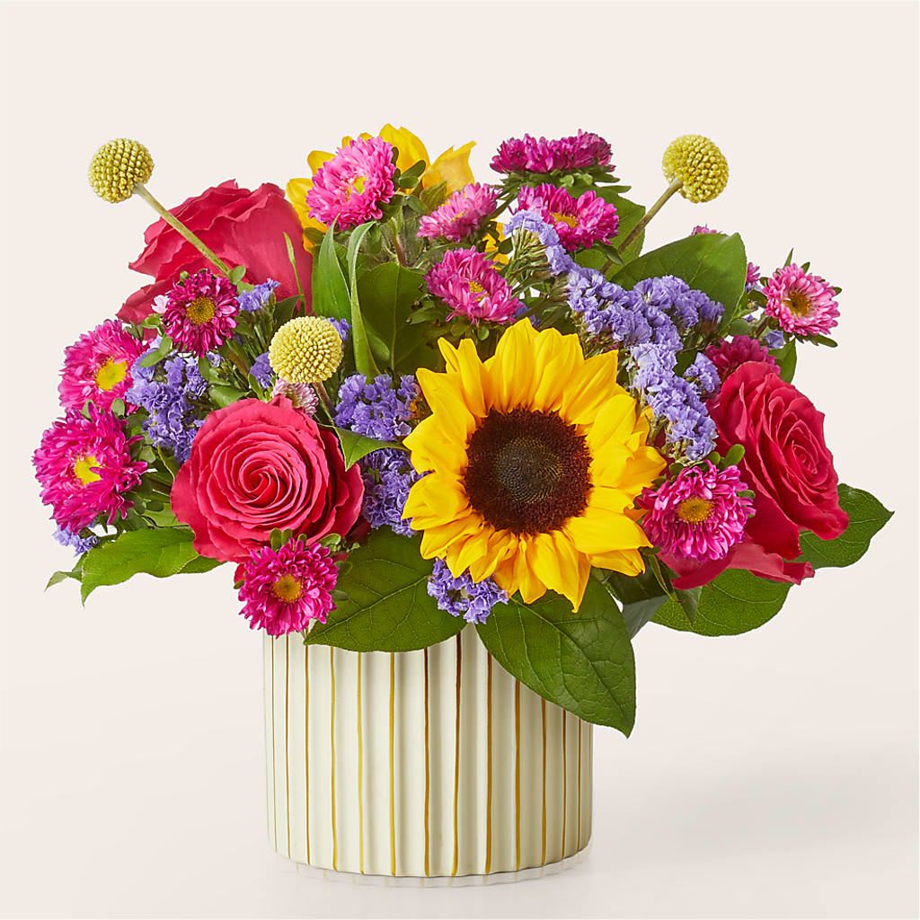 Bubbly Bouquet - A bouquet so sunny and bright you won't need a reason to celebrate, full of hot pink roses, yellow craspedia and a beaming sunflower.  3 Hot Pink 50 cm Roses 3 Yellow Craspedia stems 2 Blue Statice stems 2 Hot Pink Matsumoto Aster stems 2 Yellow Sunflowers 3 Salal tips	