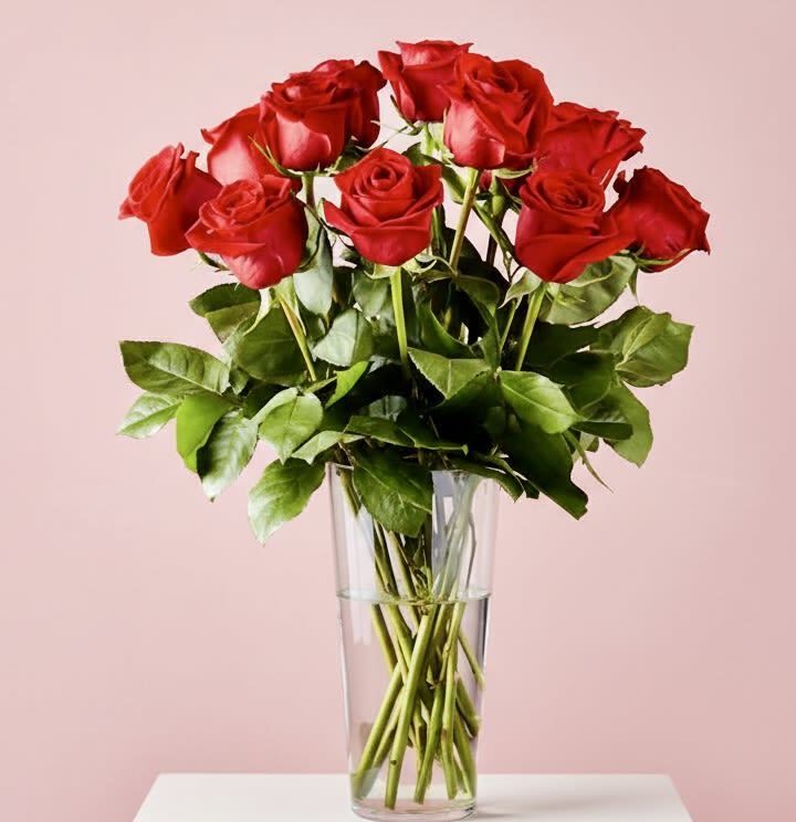 Classic long stemmed red roses - A dense, rounded bouquet of long-stemmed red roses that reads as pure romance-perfect as an anniversary bouquet or a love-and-romance gift. The vivid red blooms form a full dome that immediately says "I adore you," while the tall, clear glass vase and visible stems keep the presentation elegant and timeless. This is the kind of arrangement that makes the person you're thinking of feel truly celebrated and cherished. 