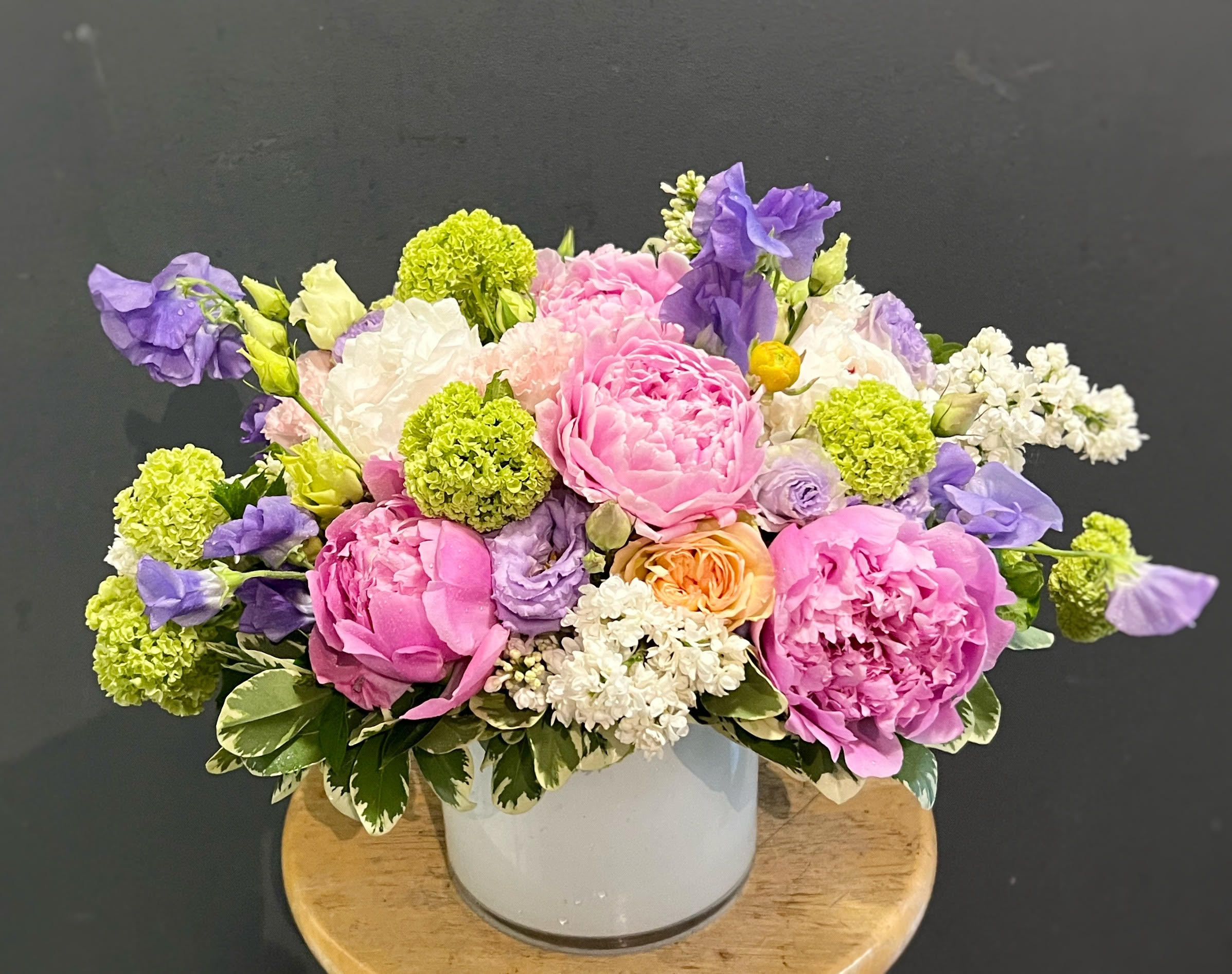 Pink and purple bouquet in a white vase