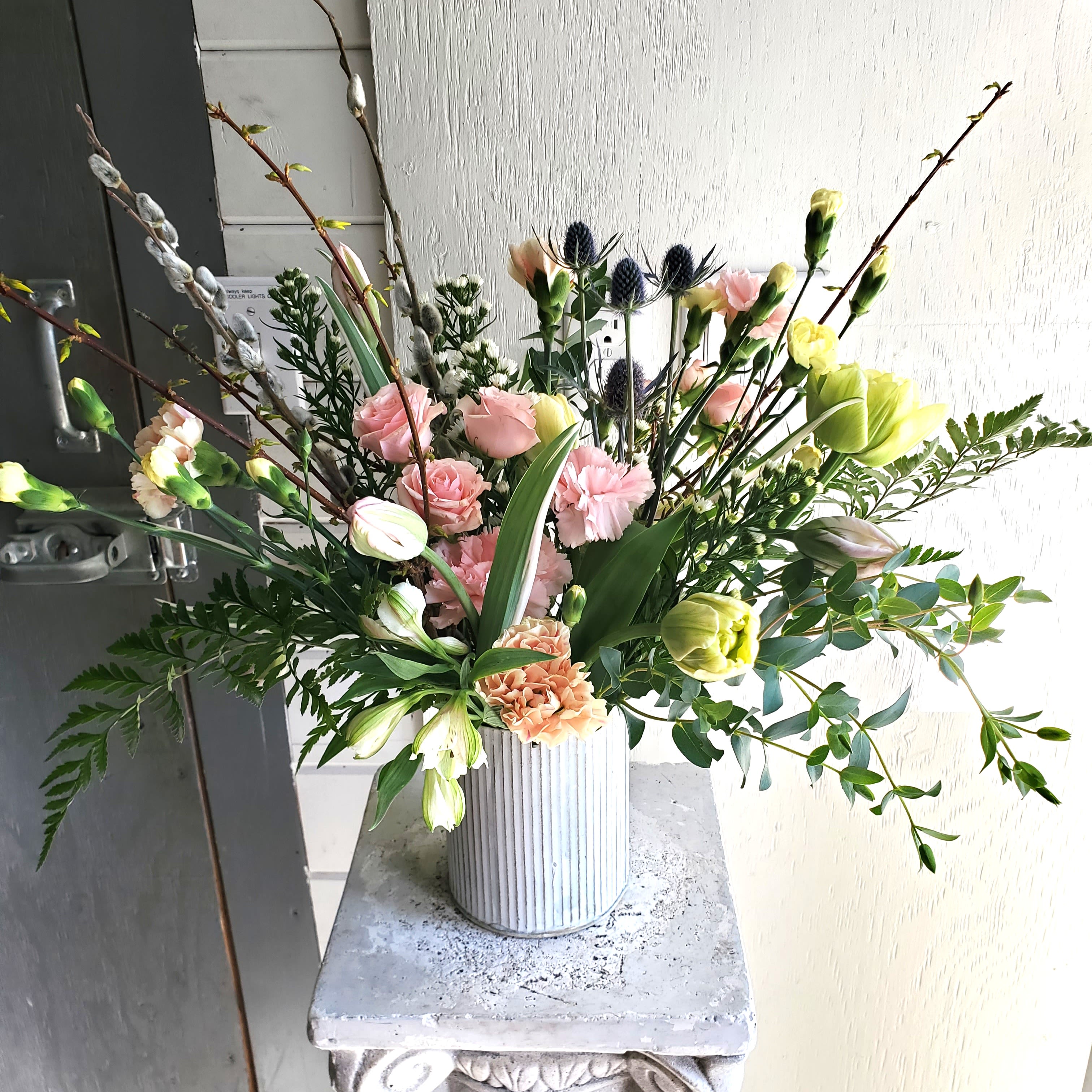 Spring Edition  - We are a small studio florist in a small town. Every bouquet we create is a one-of-a-kind creation, tailored to the season, availability of flowers, color choice, artistic interpretation, and the current materials available. The photos do not represent the exact flowers that will be delivered. They are intended to provide you with an idea of what we do, how we do it, and the variance that can be expected.The season, availability of flowers, color choice, artistic interpretation, and the current materials available. The photos do not represent the exact flowers that will be delivered. They are intended to provide you with an idea of what we do, how we do it, and the variance that can be expected. 