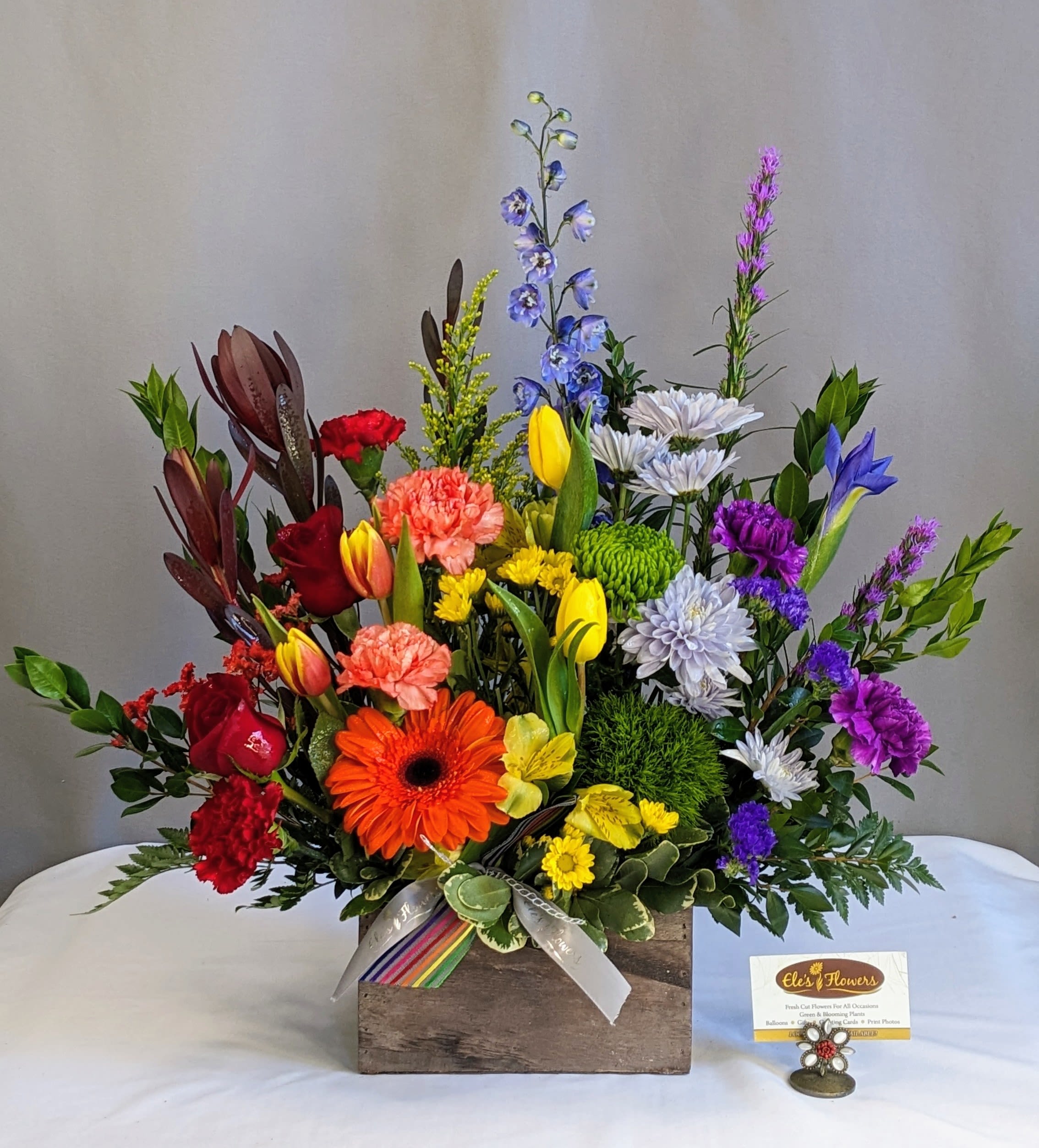 Colorful Sympathy Blooms  - Express your heartfelt condolences with our Colorful Sympathy Blooms arrangement. This exquisite bouquet features a vibrant mix of fresh, seasonal flowers, thoughtfully arranged to bring comfort and a touch of brightness during difficult times. Each arrangement is handcrafted with care, ensuring a unique and personal tribute to honor the memory of a loved one. Let our beautiful blooms convey your sympathy and support with elegance and grace.  Container and blooms may vary from photo.   Approximate Dimensions: 25"W x 22"H