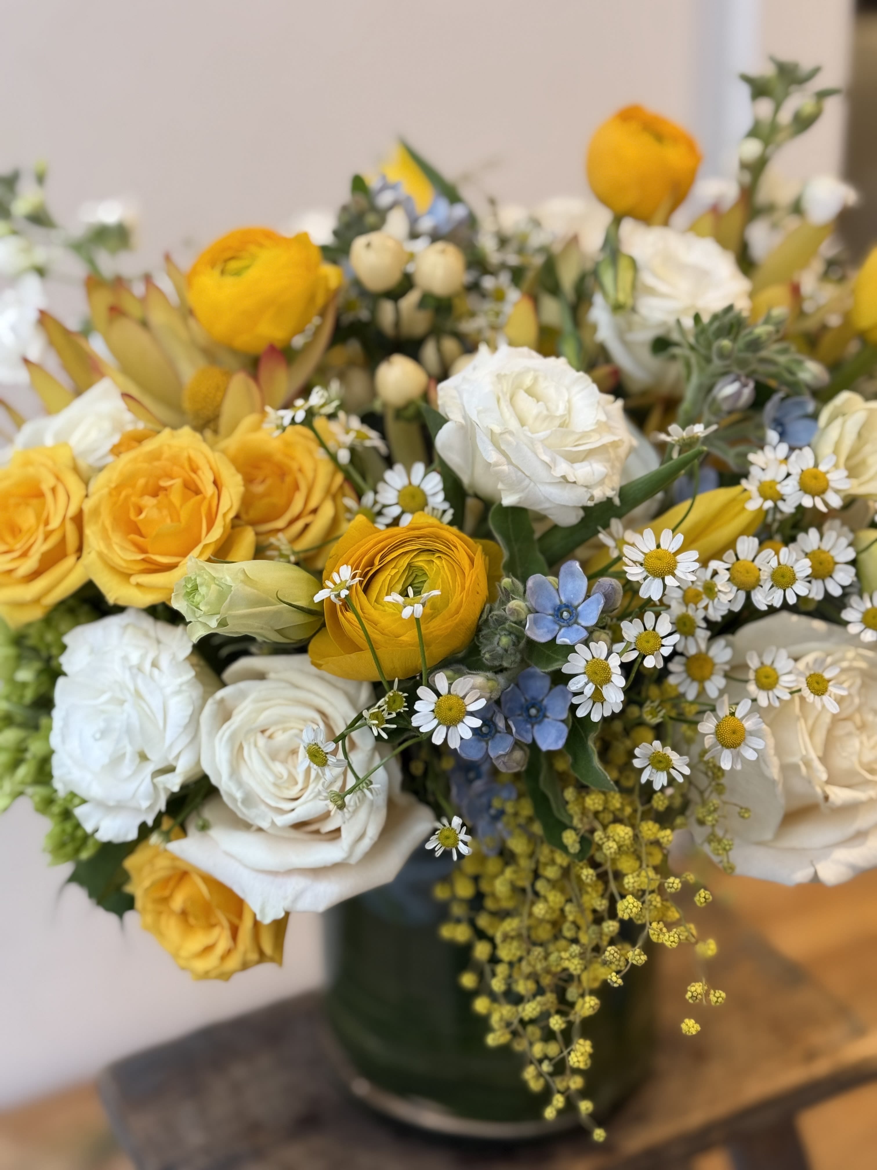 My Little Sunshine  - White and yellow flowers with a pop of blue. 