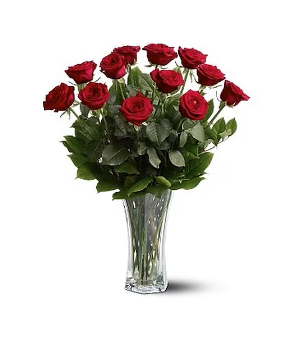 Classic Red Roses - Long Stems Red roses by Patuju Floral in Houston continue to be one of our Valentine's Day bestsellers, these classic buds symbolize love, beauty, respect, courage, devotion, and desire. This romantic bouquet includes one dozen Long stems red roses accented with lush greenery. Delivered in a clear glass vase. Standard comes with 12 red roses, Deluxe with 18 and Premium with 24 Red Roses.