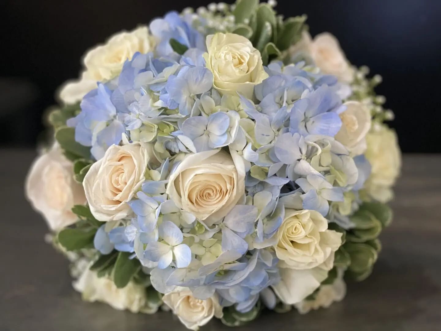 Bouquet of pale blue hydrangeas and cream roses