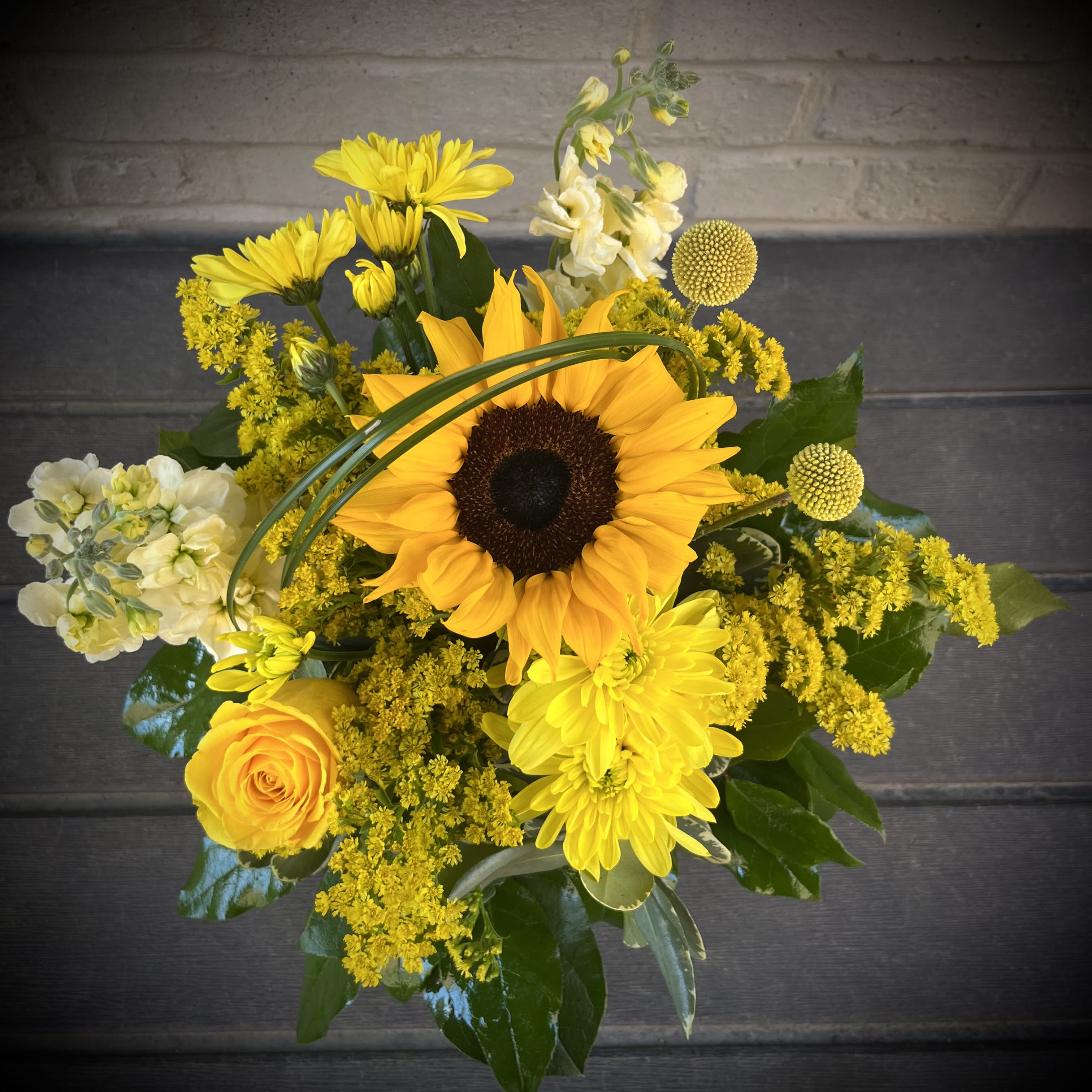 Mizzou-Rah! - Mizzou-RAH!!! Capture the spirit of the University of Missouri Tigers (located here Columbia) with this stunning design. Gold, Yellow and Black flowers express a fun Mizzou theme for any event, office, or dorm room space.  This arrangement is approximately 9.5in by 9.5in.