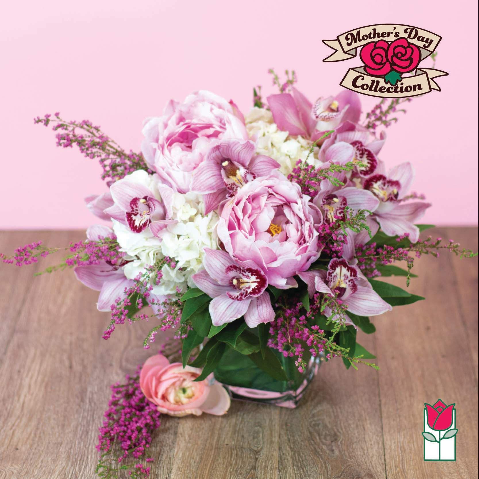 Pink and white floral arrangement in a glass vase