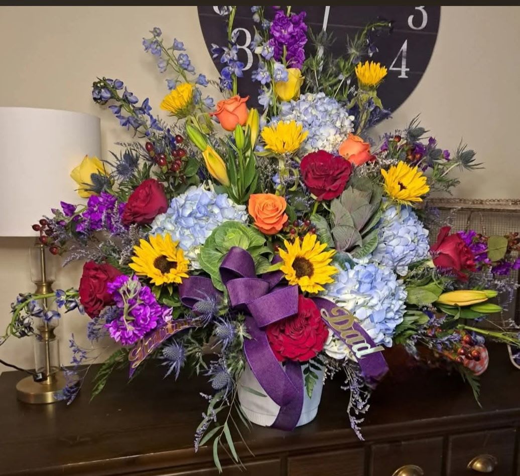 Thinking of You - Their joy and exuberance will always be remembered. This classic urn arrangement was designed to capture that lively spirit. Elegantly crafted for a lush, full presentation with vibrant blooms that remind us of a life so beautifully lived.