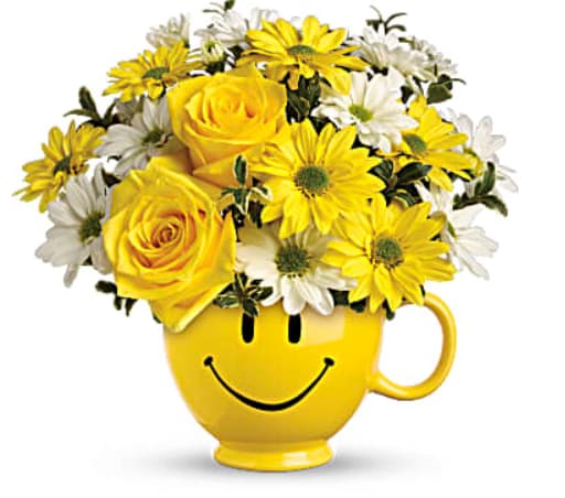 Yellow roses and daisies in a yellow smiley-face mug