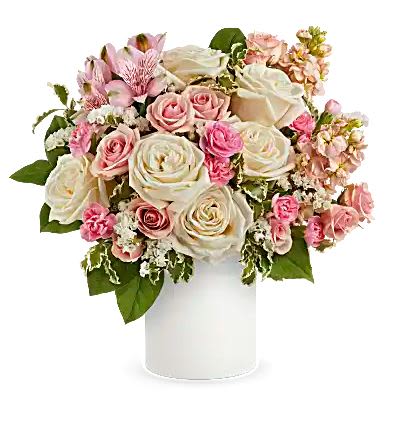 Pink and white rose bouquet in a white cylindrical vase