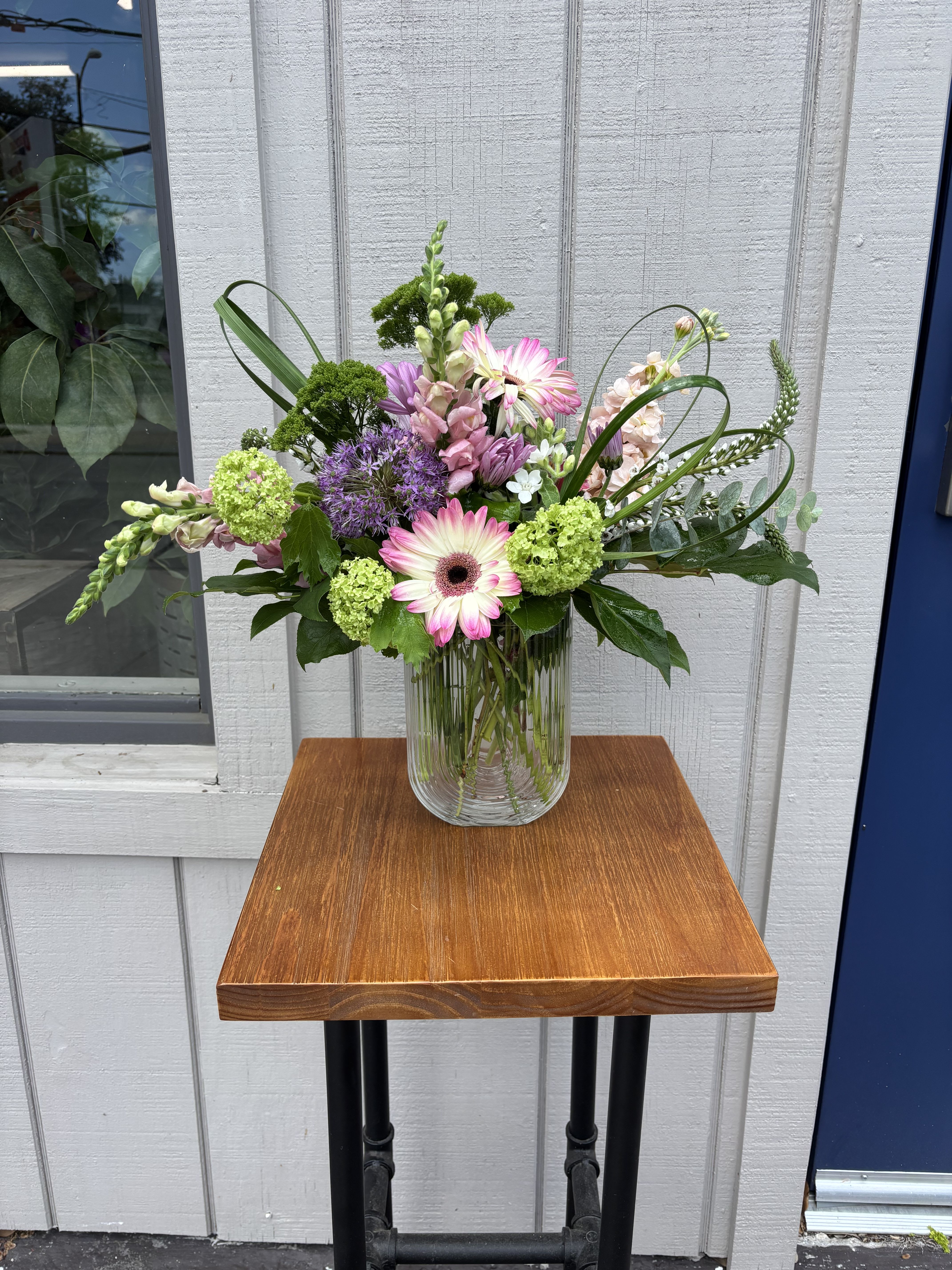 Always Happy, Never Chappy! - Assorted spring garden flowers arranged in a contemporary vase