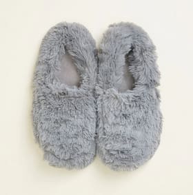 Pair of gray fuzzy slippers on a light background