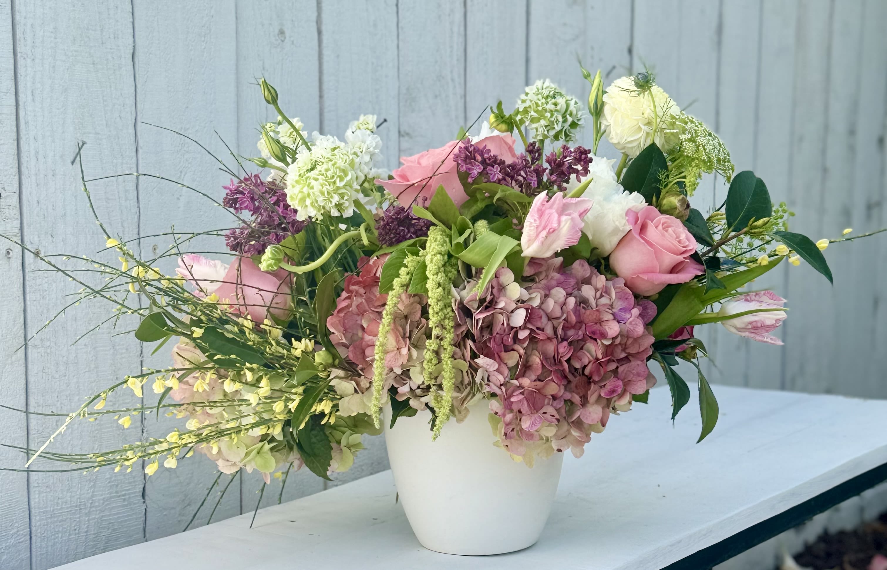 PARADISE FOUND - Springtime brings us the most beautiful flowers! This design captures those blooms with gorgeous pink hydrangeas, roses, ranunculous, tulips alongside beautiful seasonal greens.